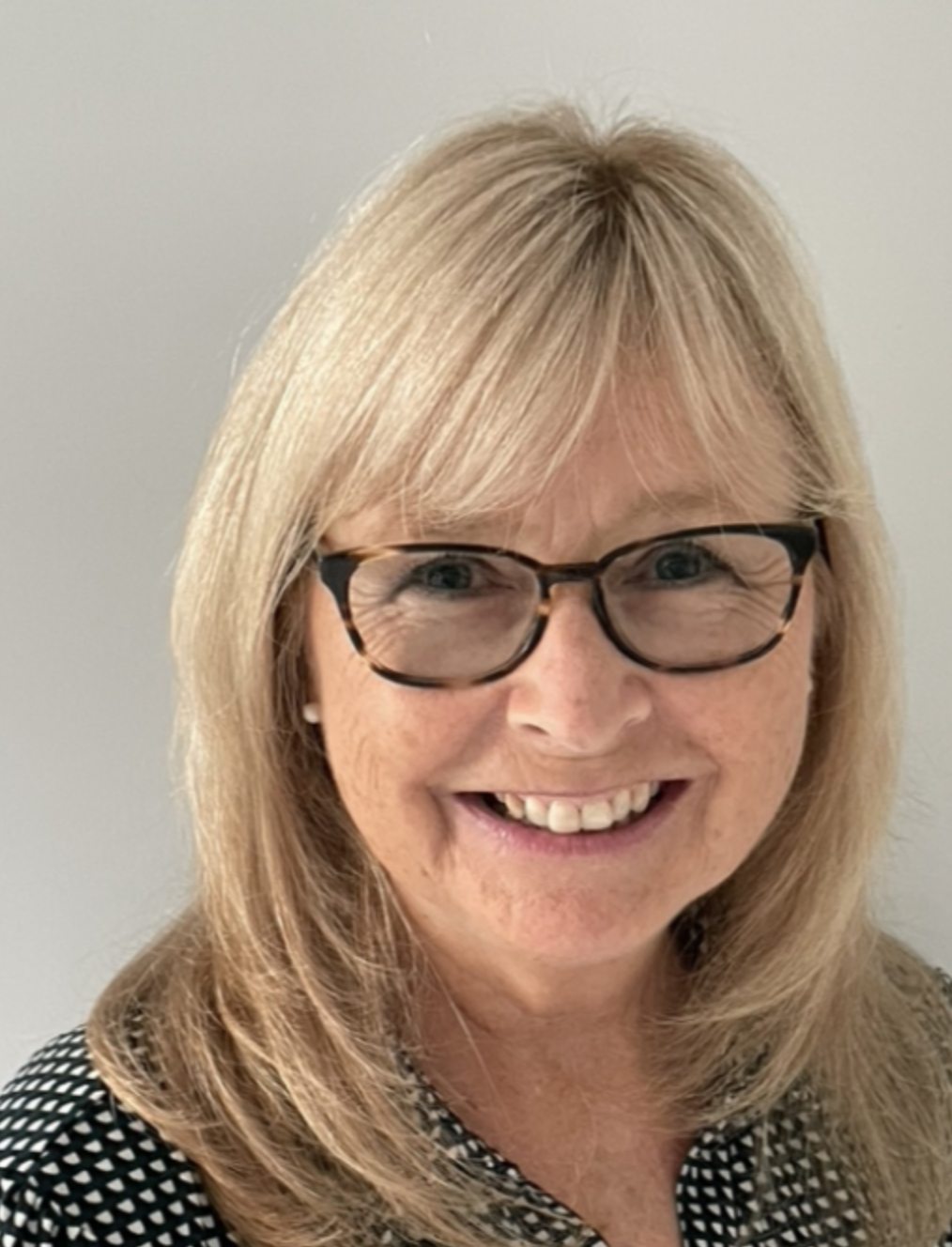 A photo of Diane Clarke Delehanty with glasses.