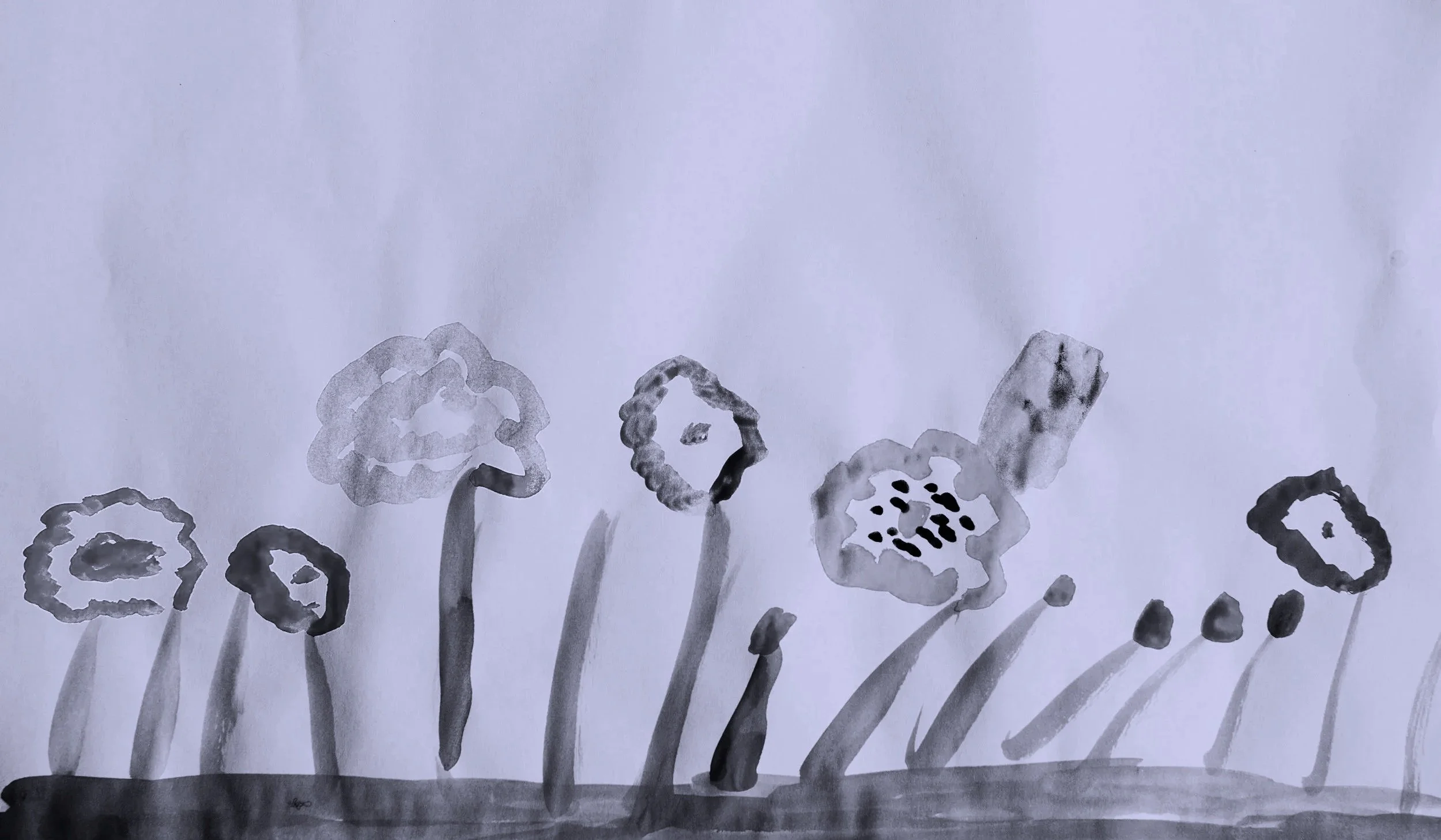 Black and white watercolor painting of seven flowers with varying shapes and sizes, some with detailed centers, on a simple ground line.