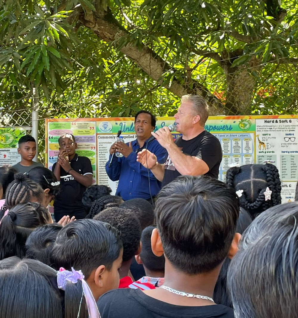 Gary Keylon ministers in Trinidad in an outdoor event at the city center. He is compelling others to come to Christ for salvation, deliverance, the baptism of the Holy Spirit, and healing.