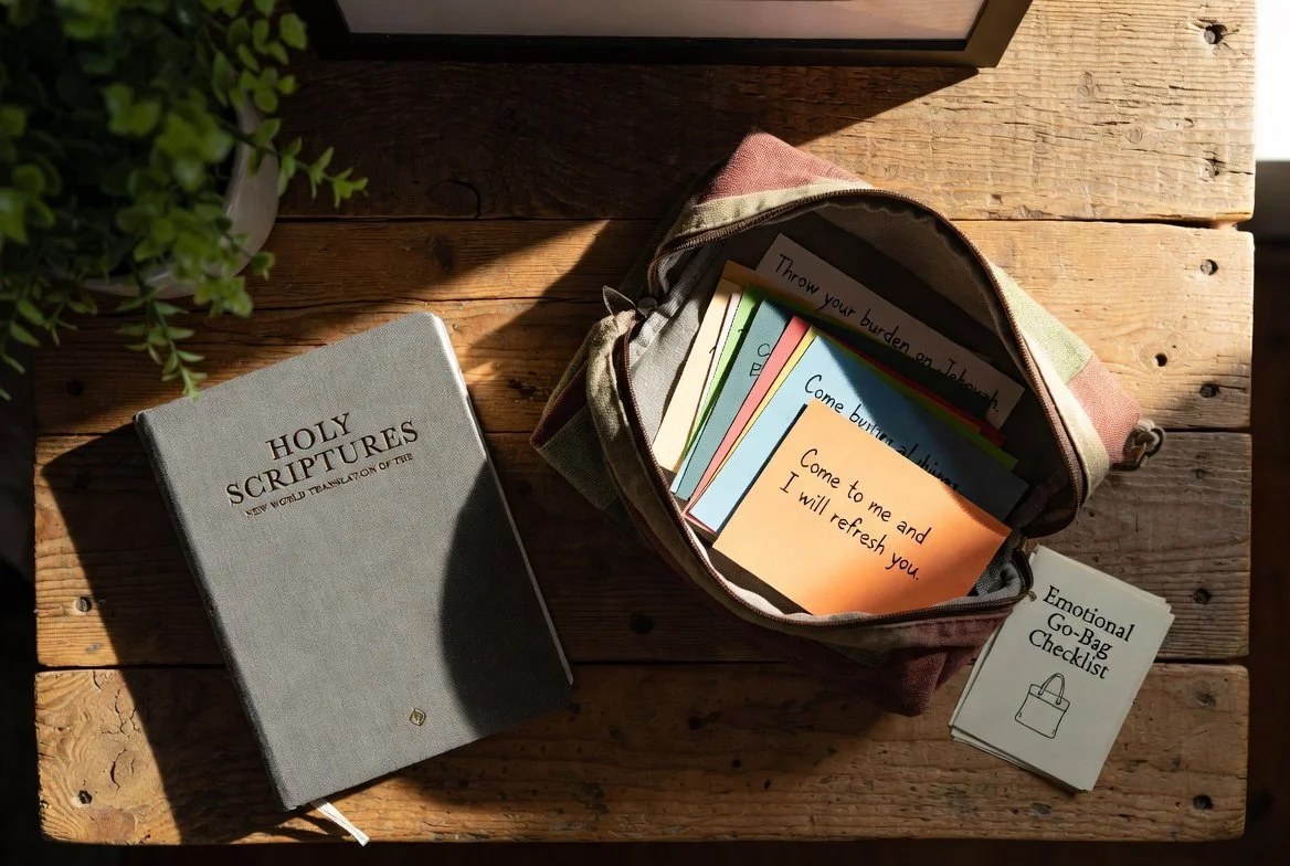 Soft fabric pouch holding scripture cards, a small journal, and printed reminders open on a sunlit table—emotional go-bag for Christian spiritual strength