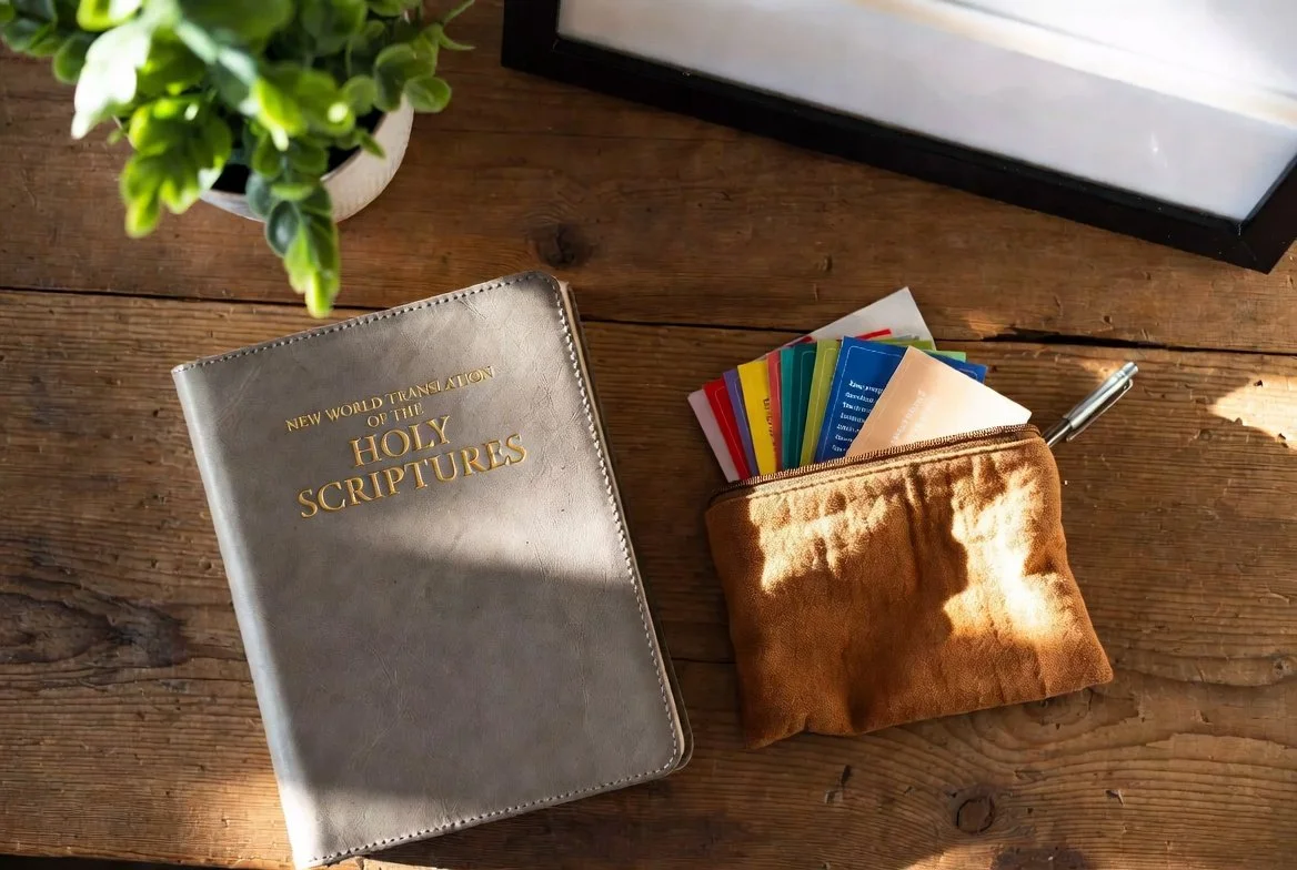 Soft fabric pouch holding scripture cards, a small journal, and printed reminders open on a sunlit table—emotional go-bag for Christian spiritual strength