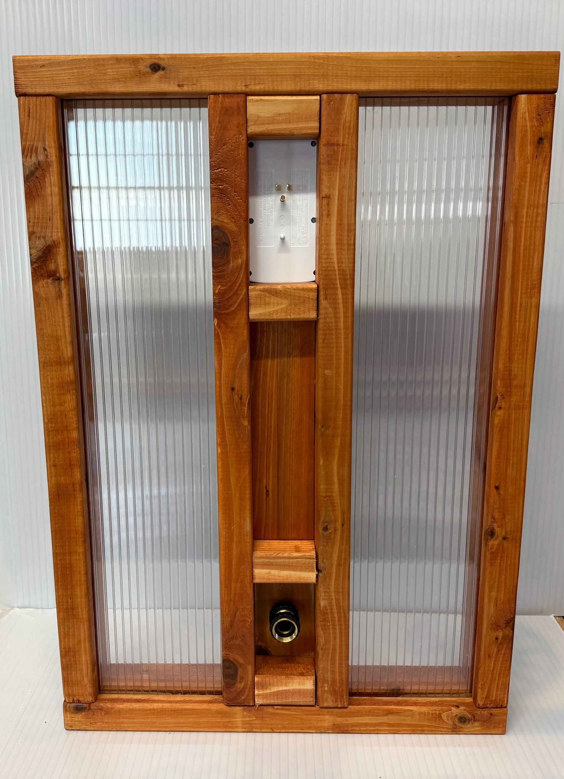 Wooden utility panel with electrical outlets and water spigot