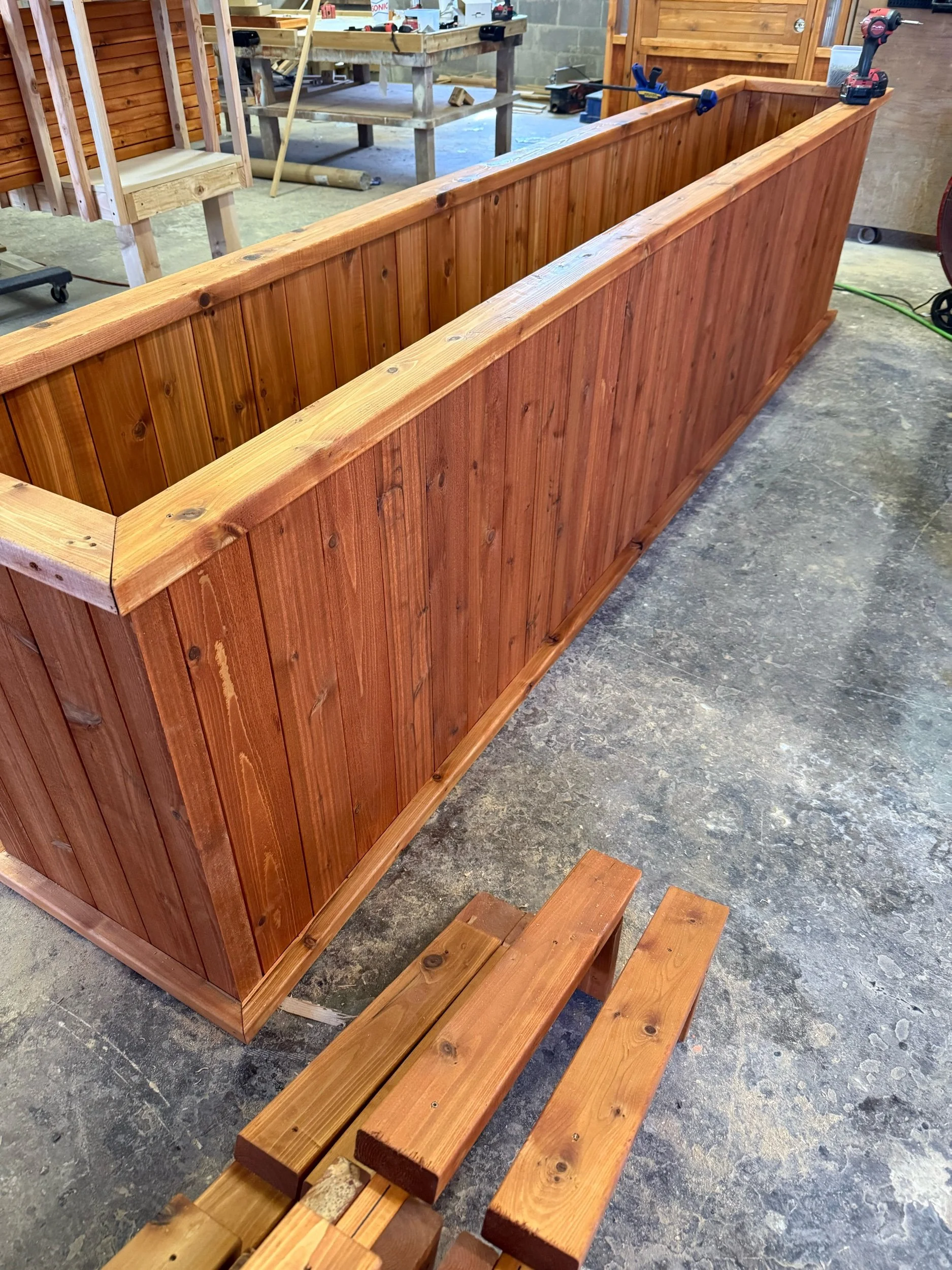Stained wooden raised garden bed, side view