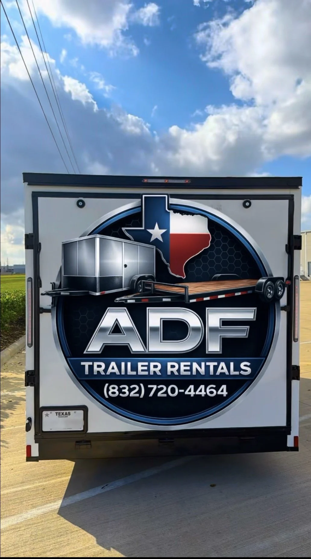 The back of a trailer rental truck with a logo featuring a Texas shape with a star, an enclosed cargo trailer, and the text "ADF Trailer Rentals" with a phone number.