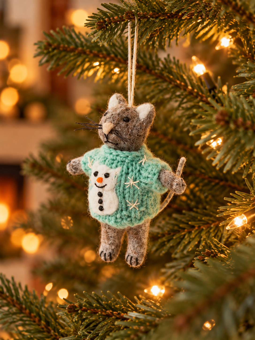 Lone felt cat on a fir branch.png