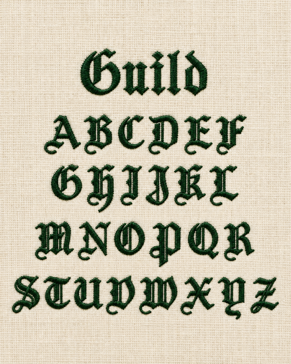 Embroidery of the alphabet in gothic style on beige fabric, with the word 'Guil'd' embroidered at the top.