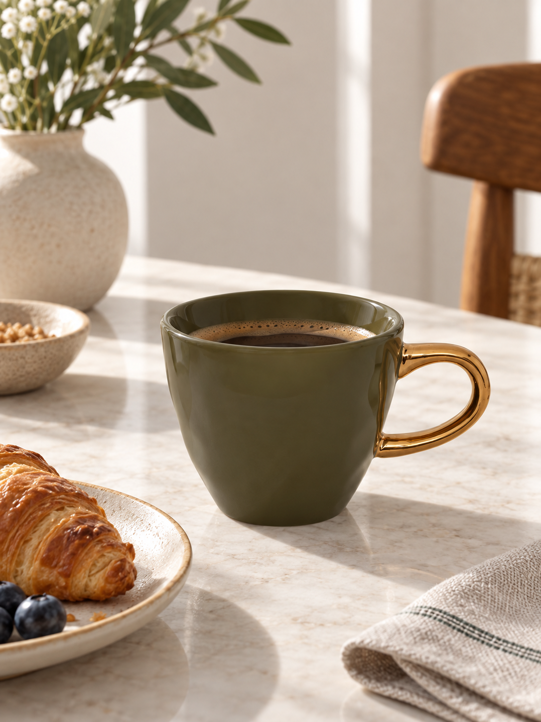 green gold coffee cup in use.png