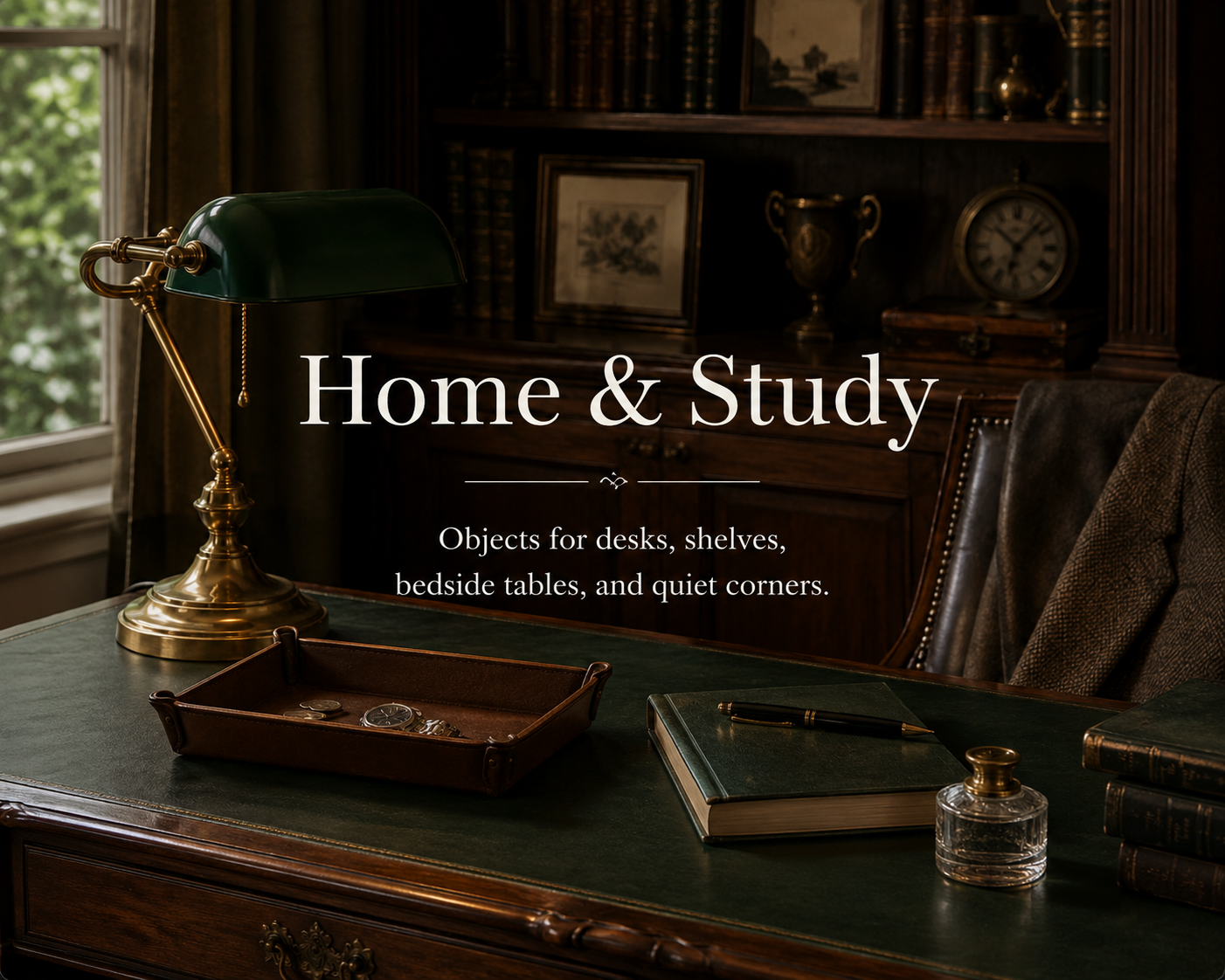 Vintage home office with a dark wooden desk, green banker-style lamp, leather chair, and shelves filled with books and decorative items. The room has a window letting in natural light.