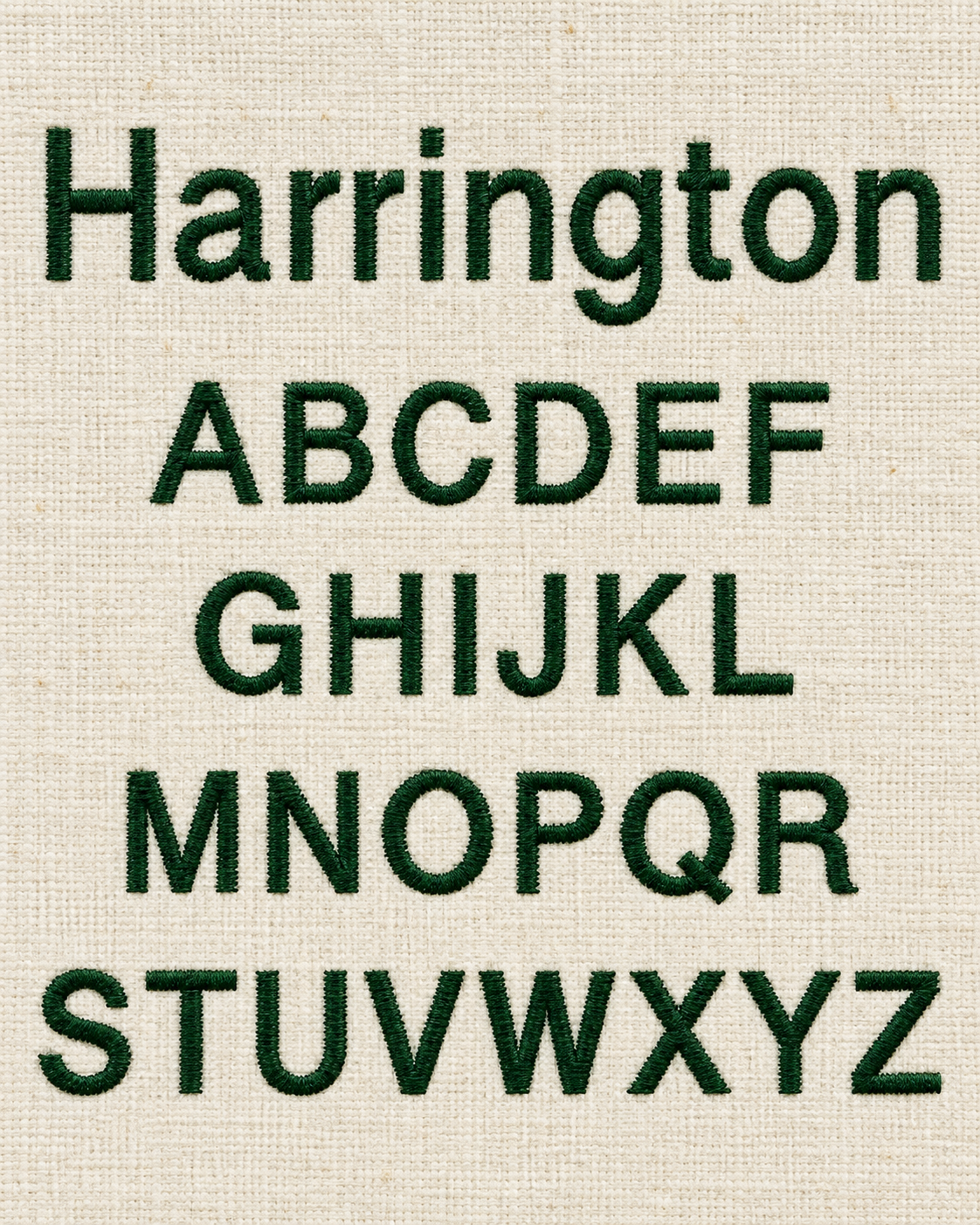 Embroidery of the alphabet from A to Z in green thread on a beige fabric background.