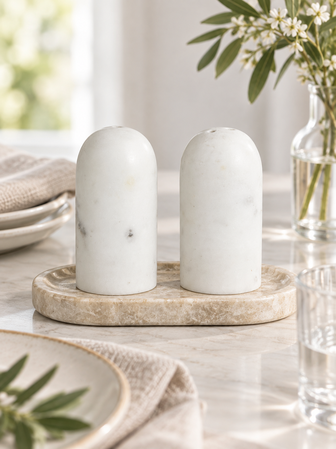 white marble salt and pepper shakers on table.png