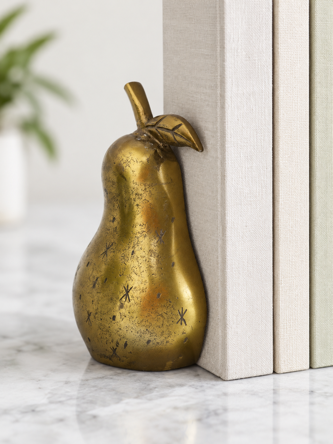 single golden pear bookend.png