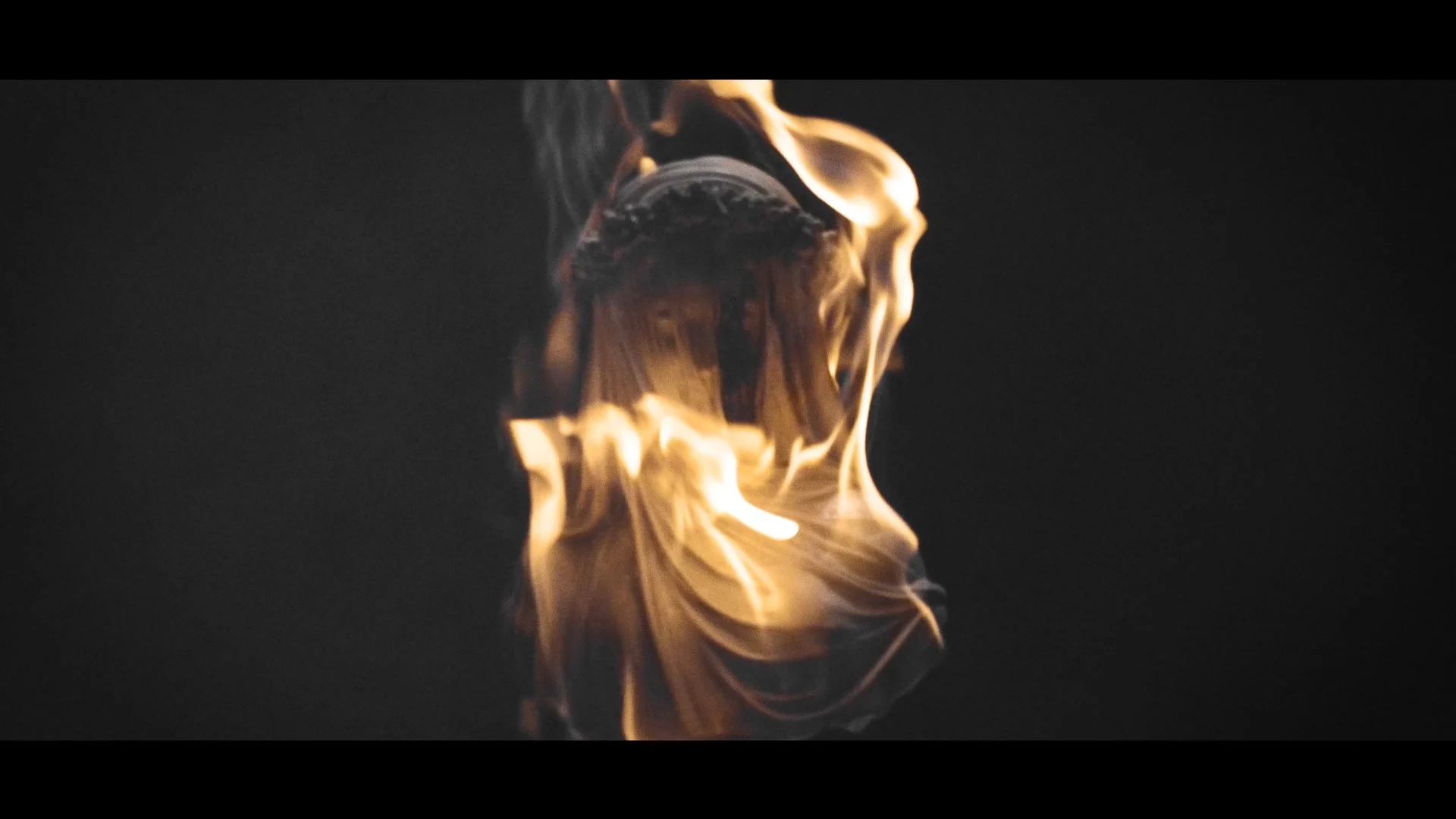 Flammen und Rauch umwickeln eine Person, die in der Dunkelheit steht, erschaffend eine dramatische Szene.