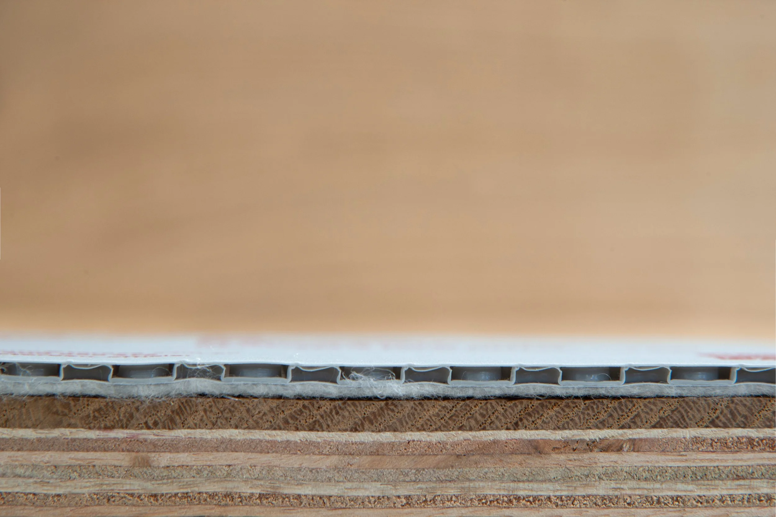 Close-up of the cross-section of a cardboard box showing its layered structure.