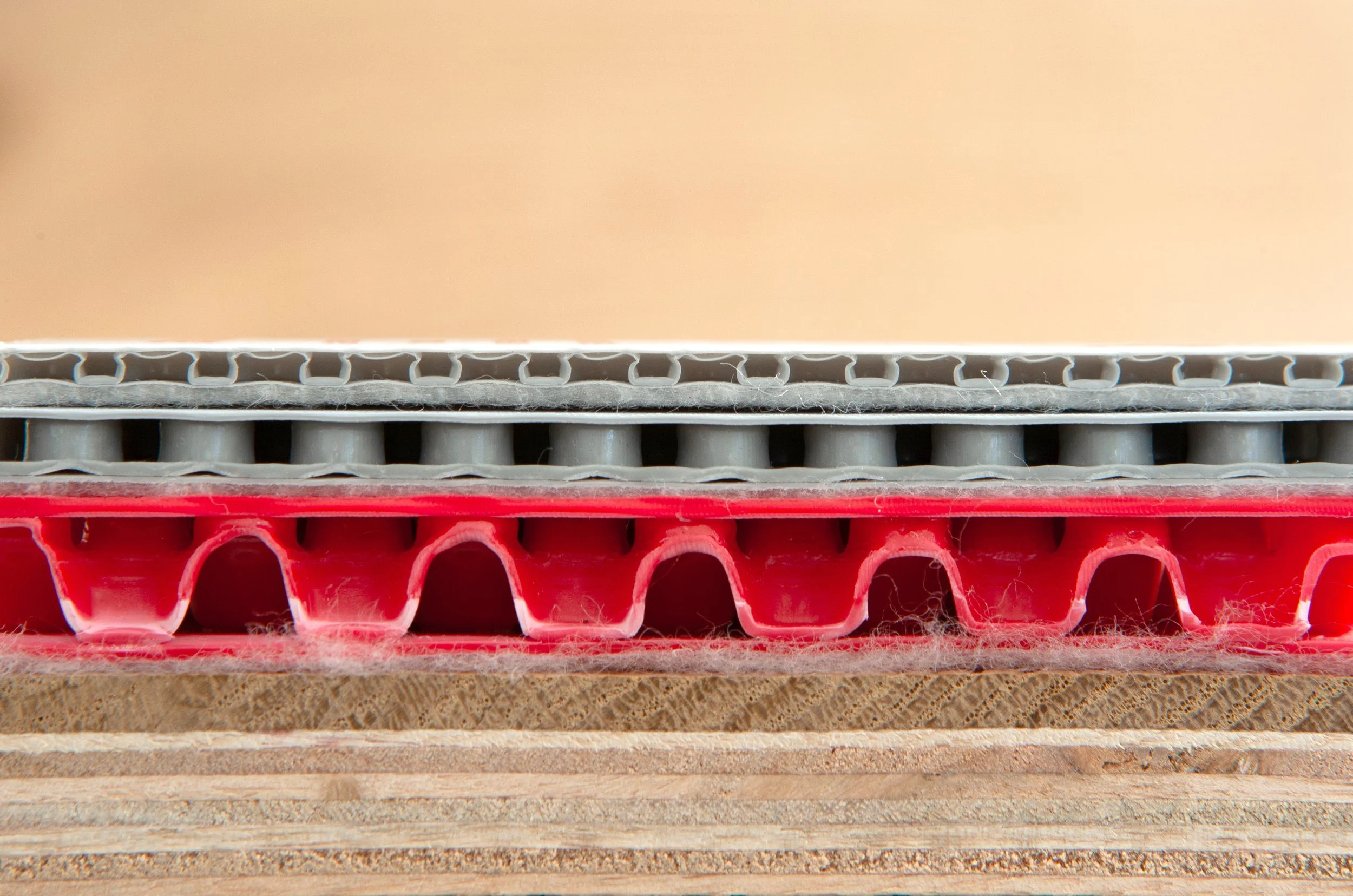 Close-up of multiple layers of cardboard and plastic crates stacked together, showing different textures and colors.