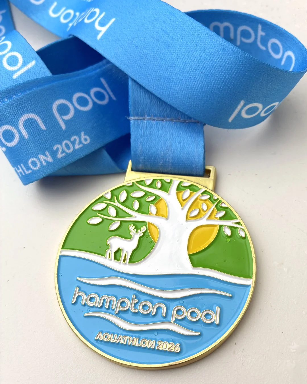 Branding and medal design for Hampton Open Air Pool’s inaugural Aquathlon. A 430m swim followed by a 5km run in neighbouring iconic home to roaming deer and ancient trees, Royal Bushy Park