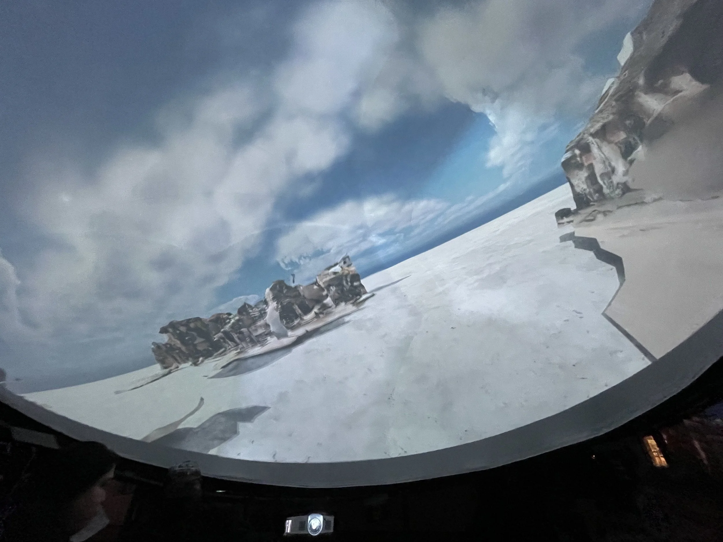 A projection of a 3D scanned city landscape on a dome shaped screen