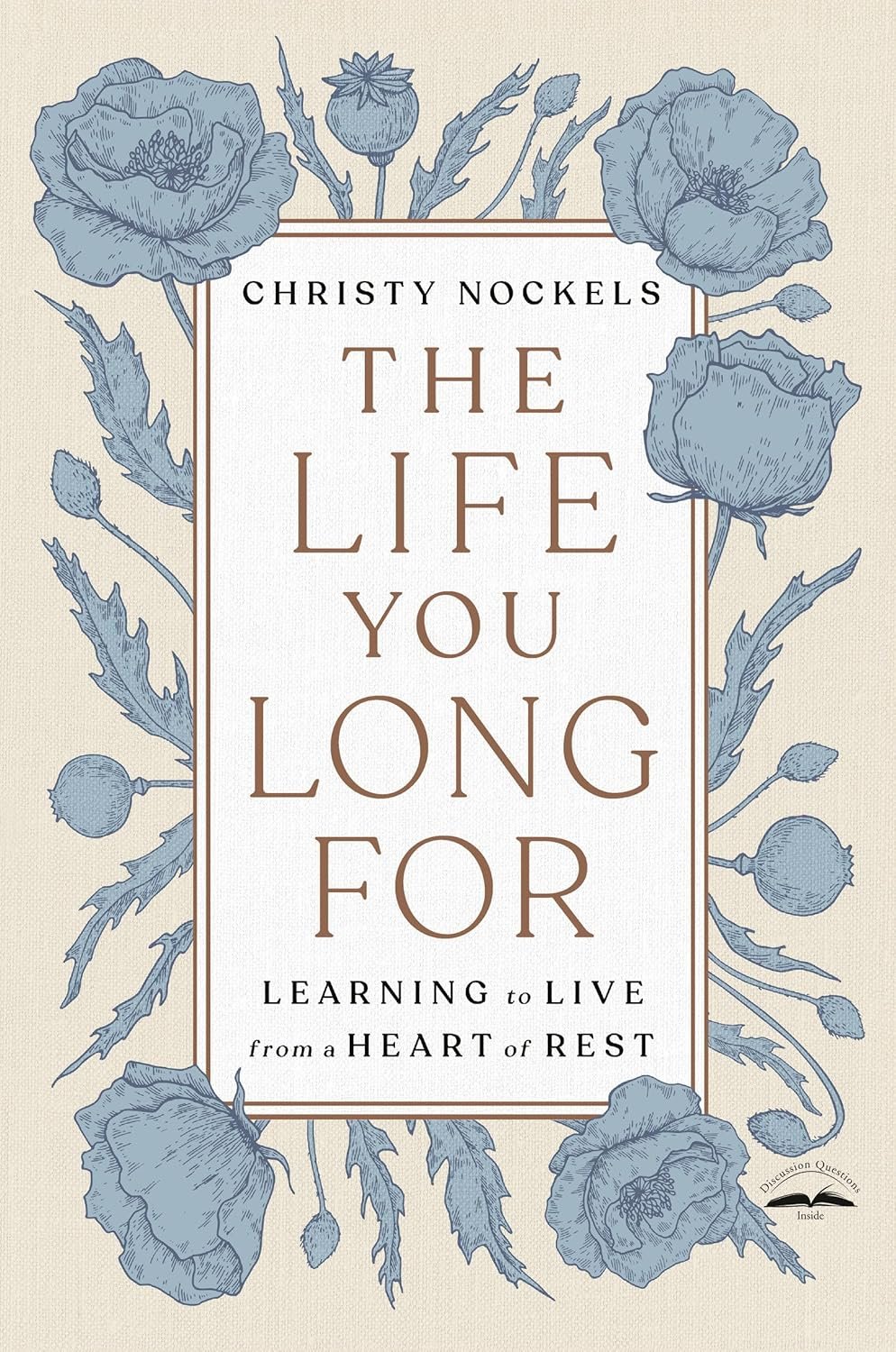 Book cover titled "The Life You Long For" by Christy Nockels, featuring a beige background with blue floral illustrations, including poppies and buds.