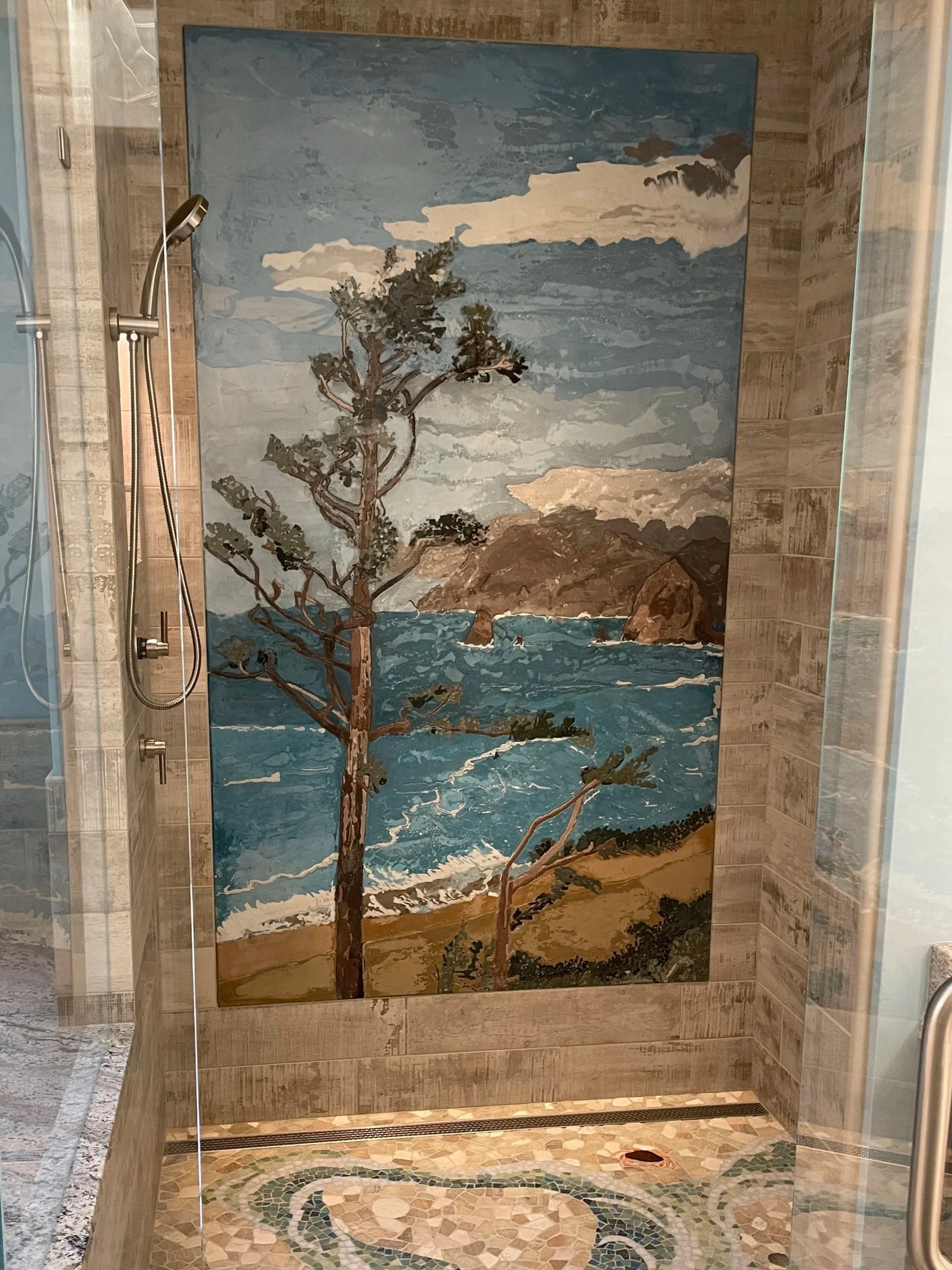 Concrete Mural of a scenic coastal landscape with a tree in the foreground, ocean waves, rocky islands, and cloudy sky, in an indoor shower.