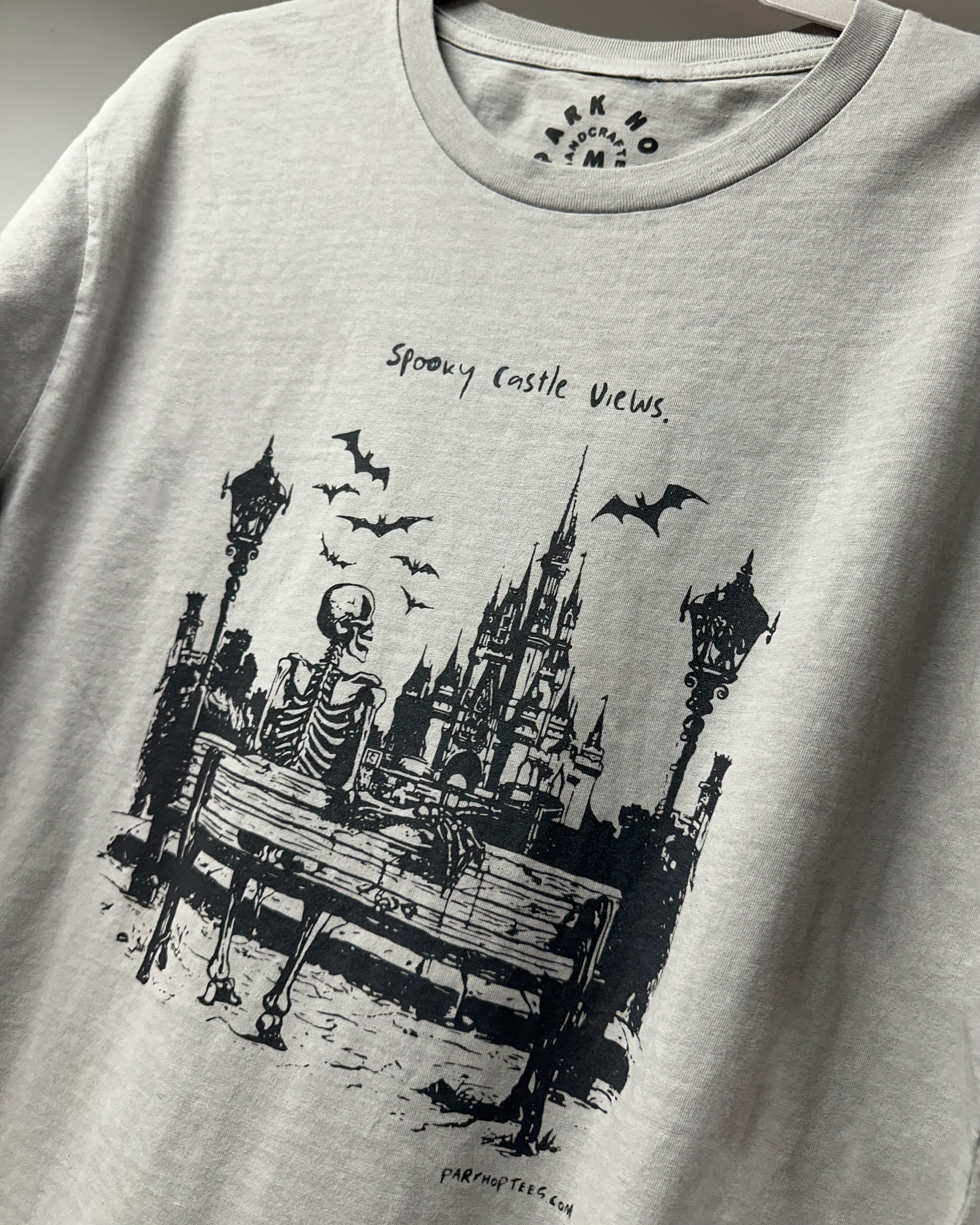 park hop tees spooky tees hand drawn skeleton castle views tee.PNG