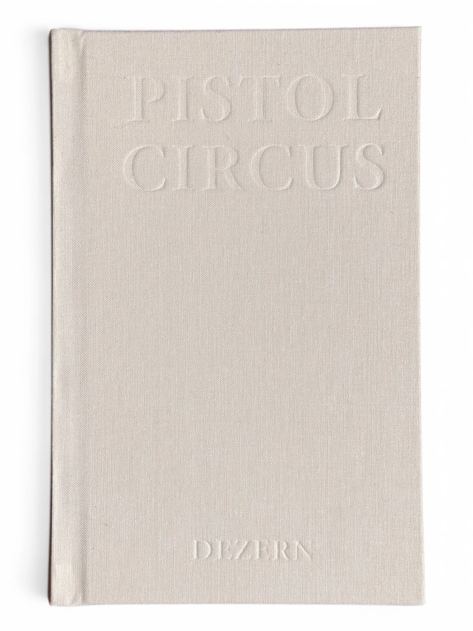 A white book with raised text on the cover that reads 'PSYCHOL CIRCUS'. The cover has a textured surface and the book is placed on a white background.