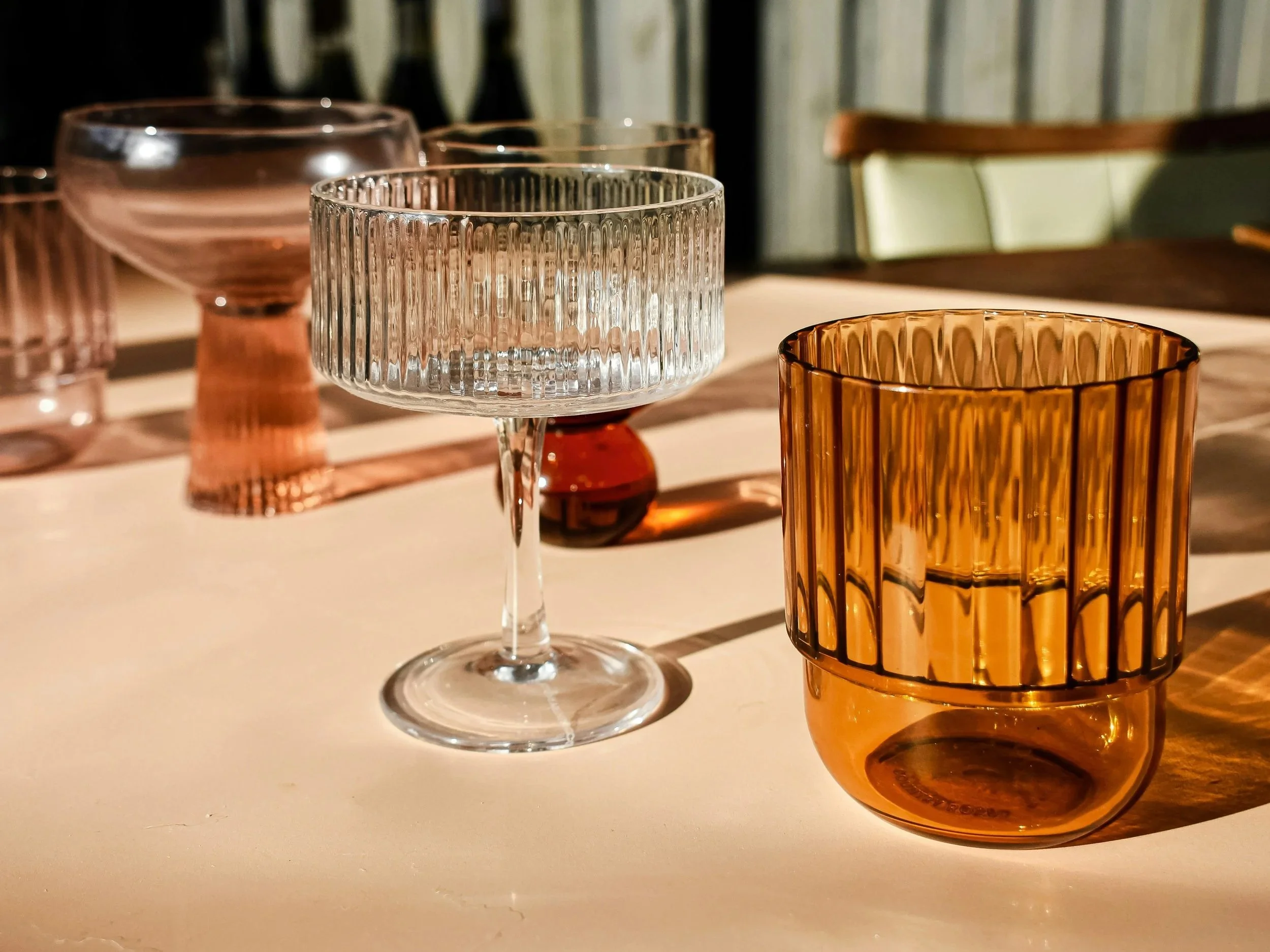 a mix of different clean modern glassware sitting on a table