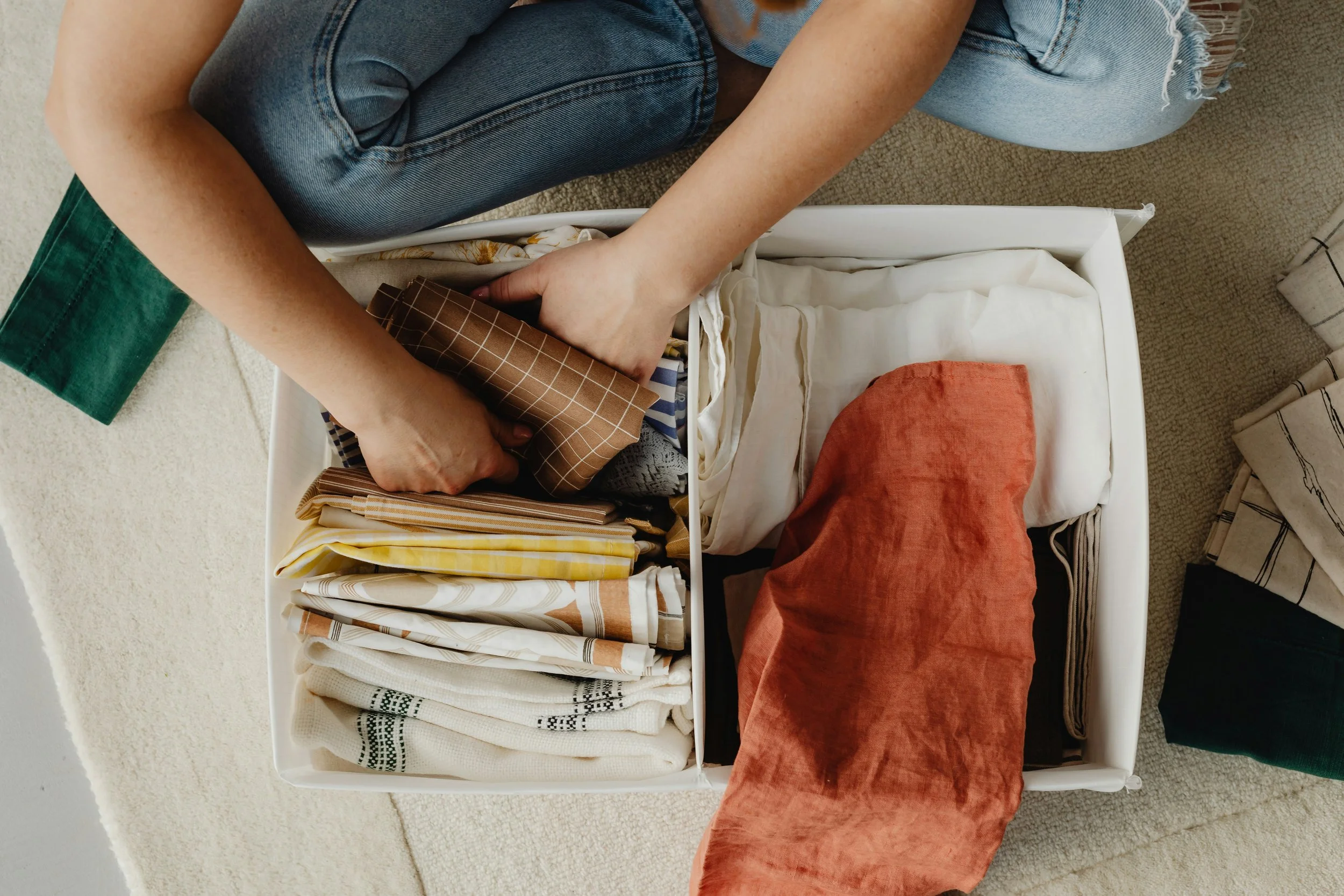 linen napking being sorted through in a storage bin