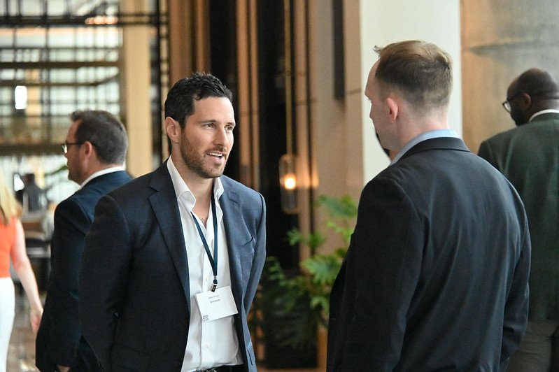 Jack Stone speaking with industry professionals at a commercial real estate event