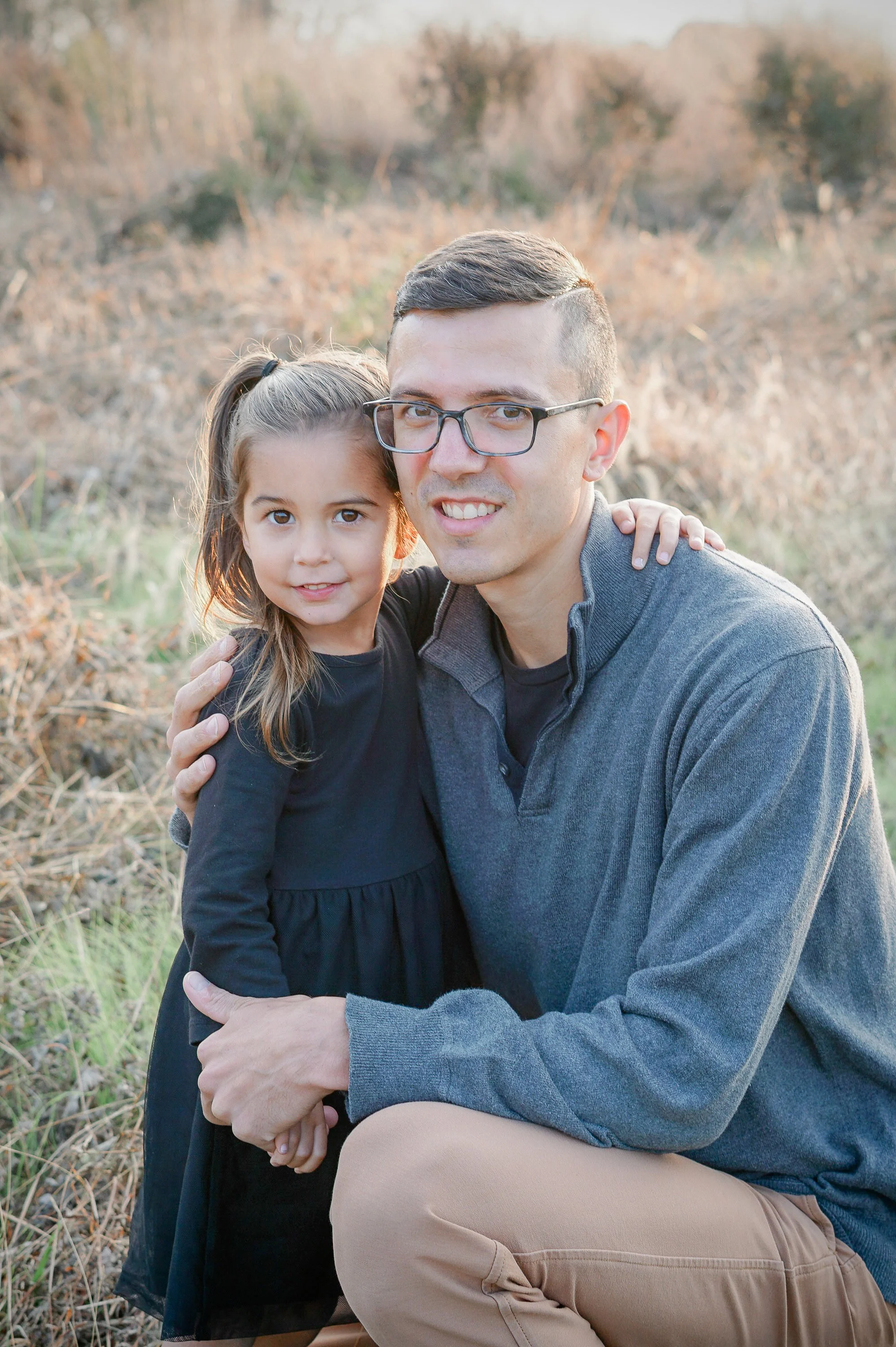 A father and daughter hugging for the camera at their photo session at the Pennypack on the Delaware Park in Philadelphia. 