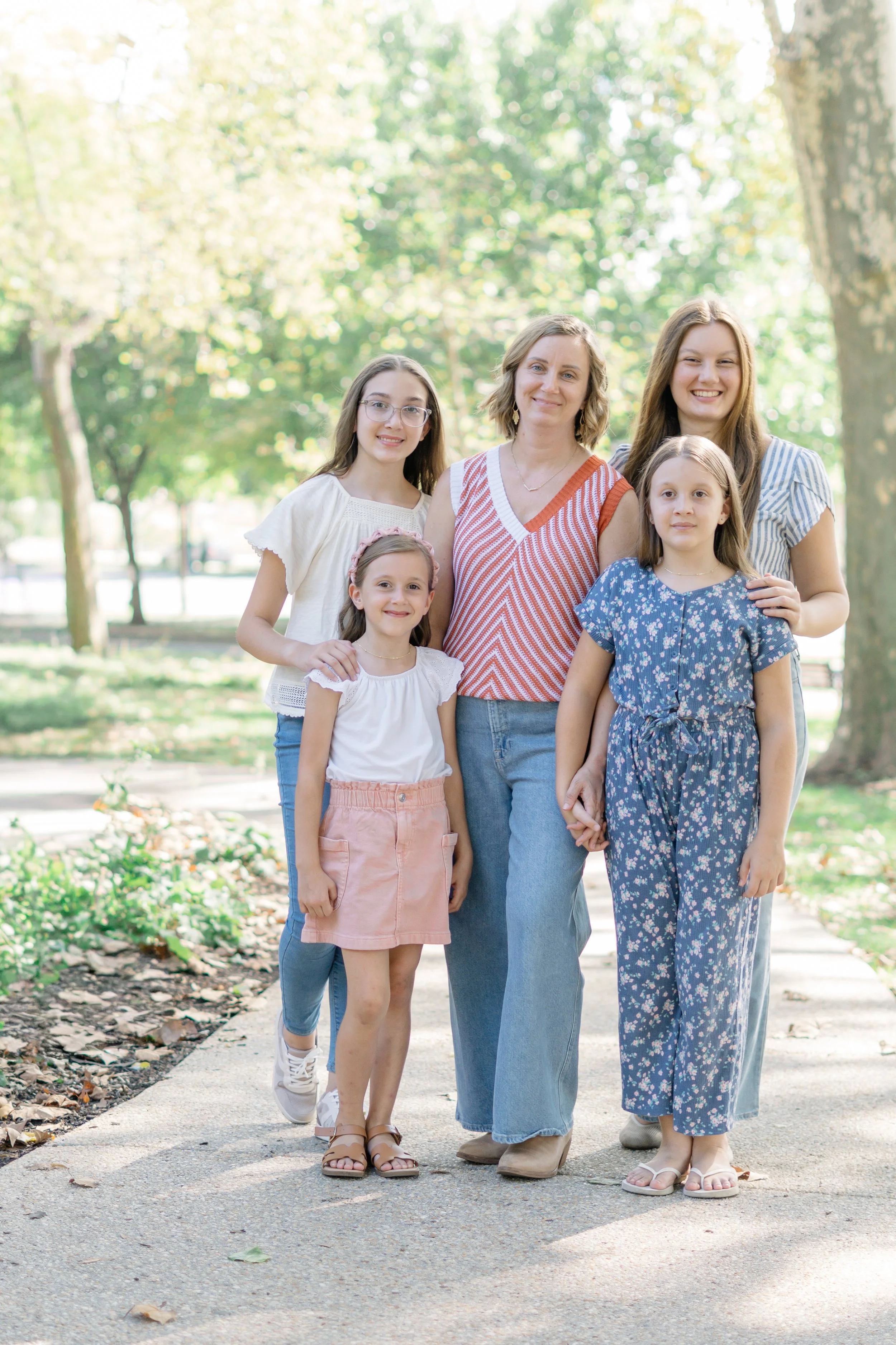 Laurie’s customers, Mariana and Carmen holding hands on a green lawn on their wedding day.