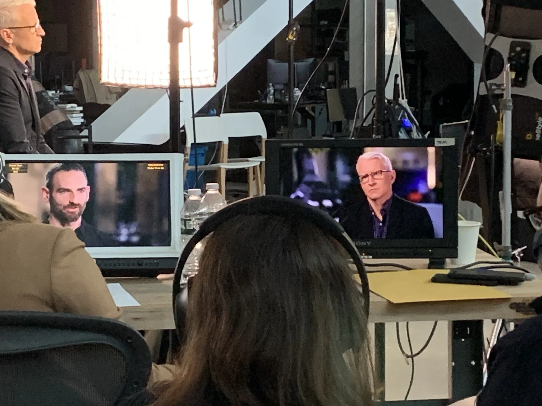 Behind the scenes of a video or photography shoot.  Kevin Blankespoor and Anderson Cooper during the filming of 60 Minutes episode on Boston Dynamics.