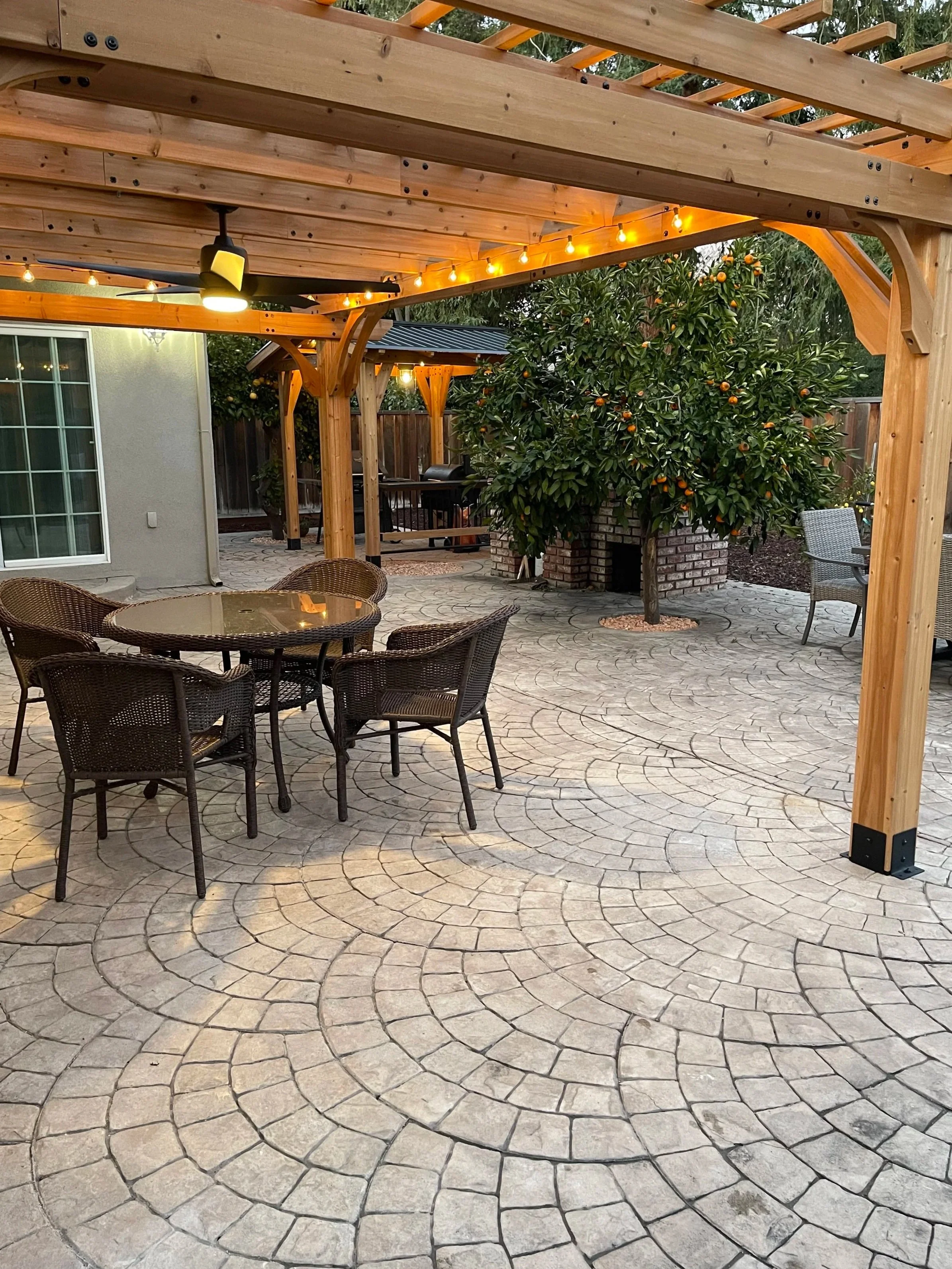 Covered patio renovation featuring custom overhead framing that defines a shaded outdoor gathering space and creates a seamless continuation of the home.