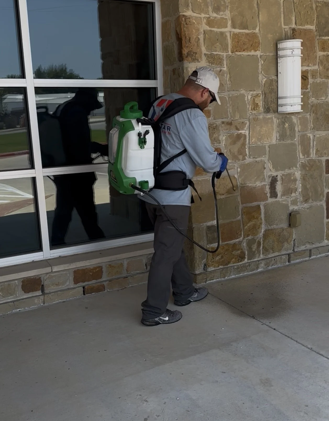 Commercial pest control service using backpack sprayer in DFW area