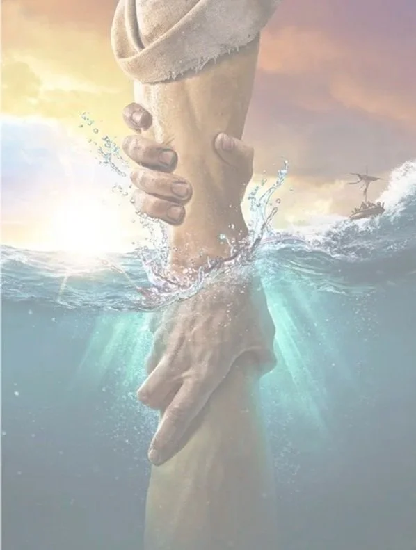 A pair of hands holding onto each other, partially submerged in water, with a boat and a rocky shoreline in the background during sunset.