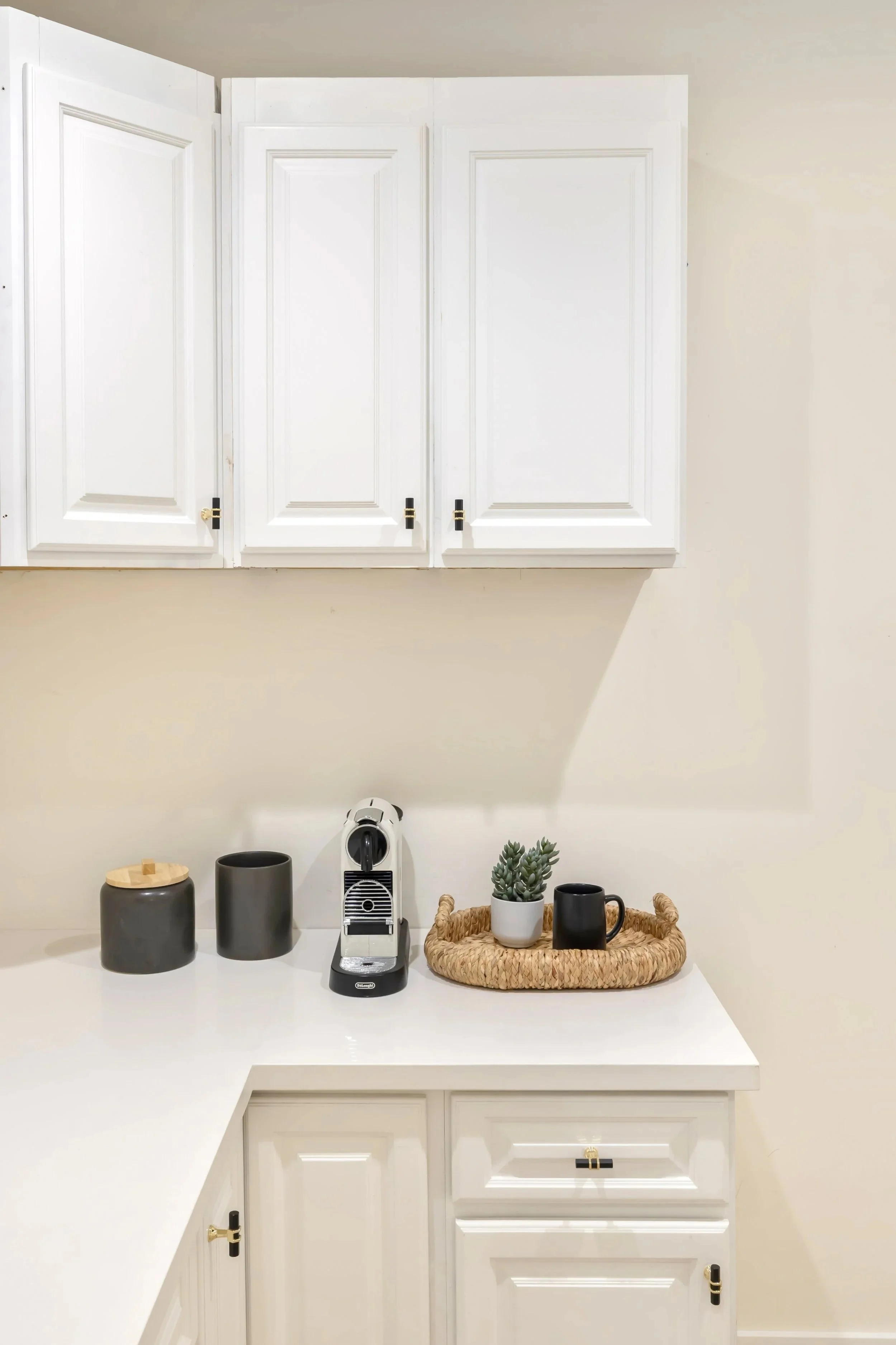 Pantry with white cabinetry, quartz countertop and brass and marble accents.