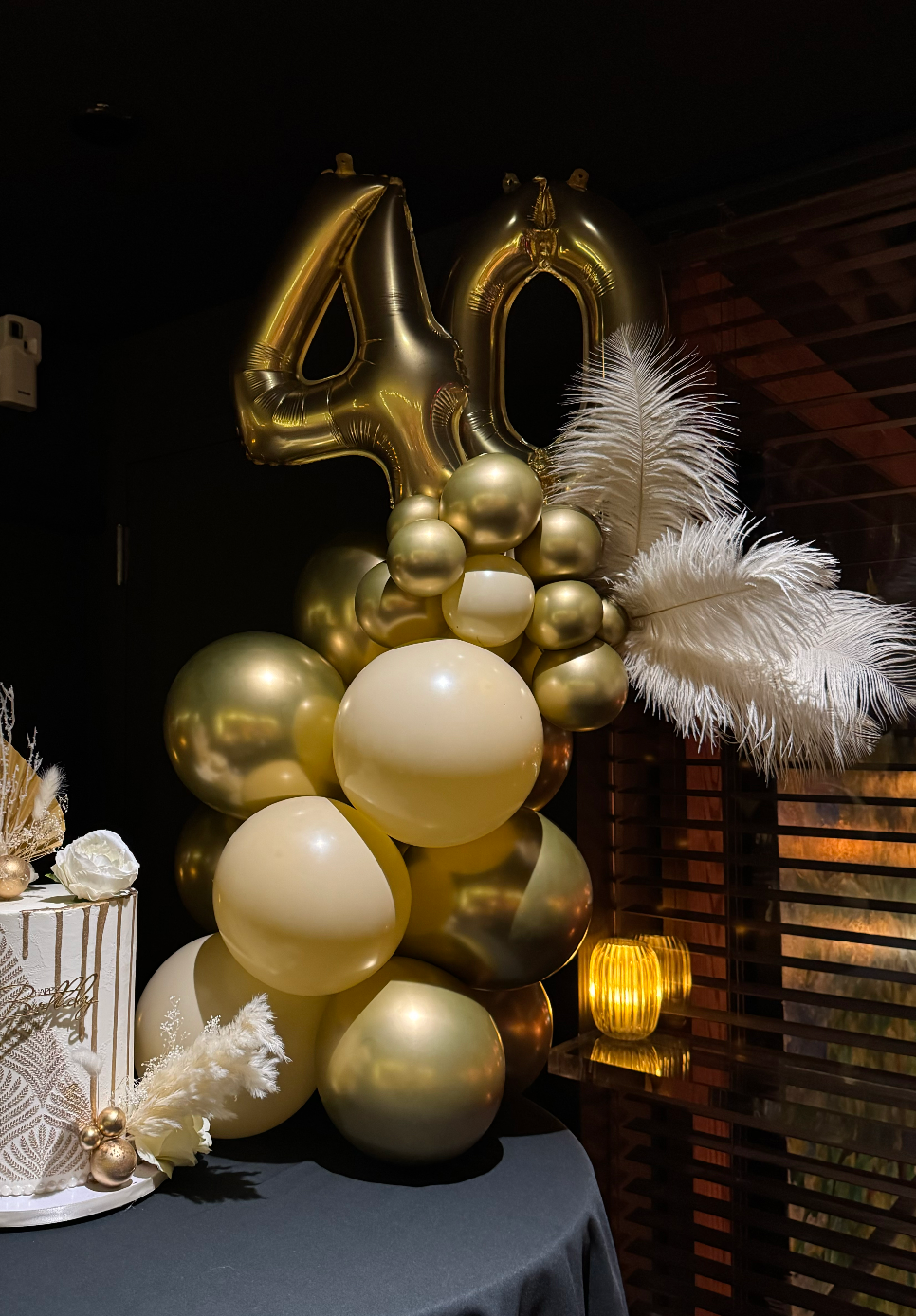 Cream feather 40th birthday balloon stack