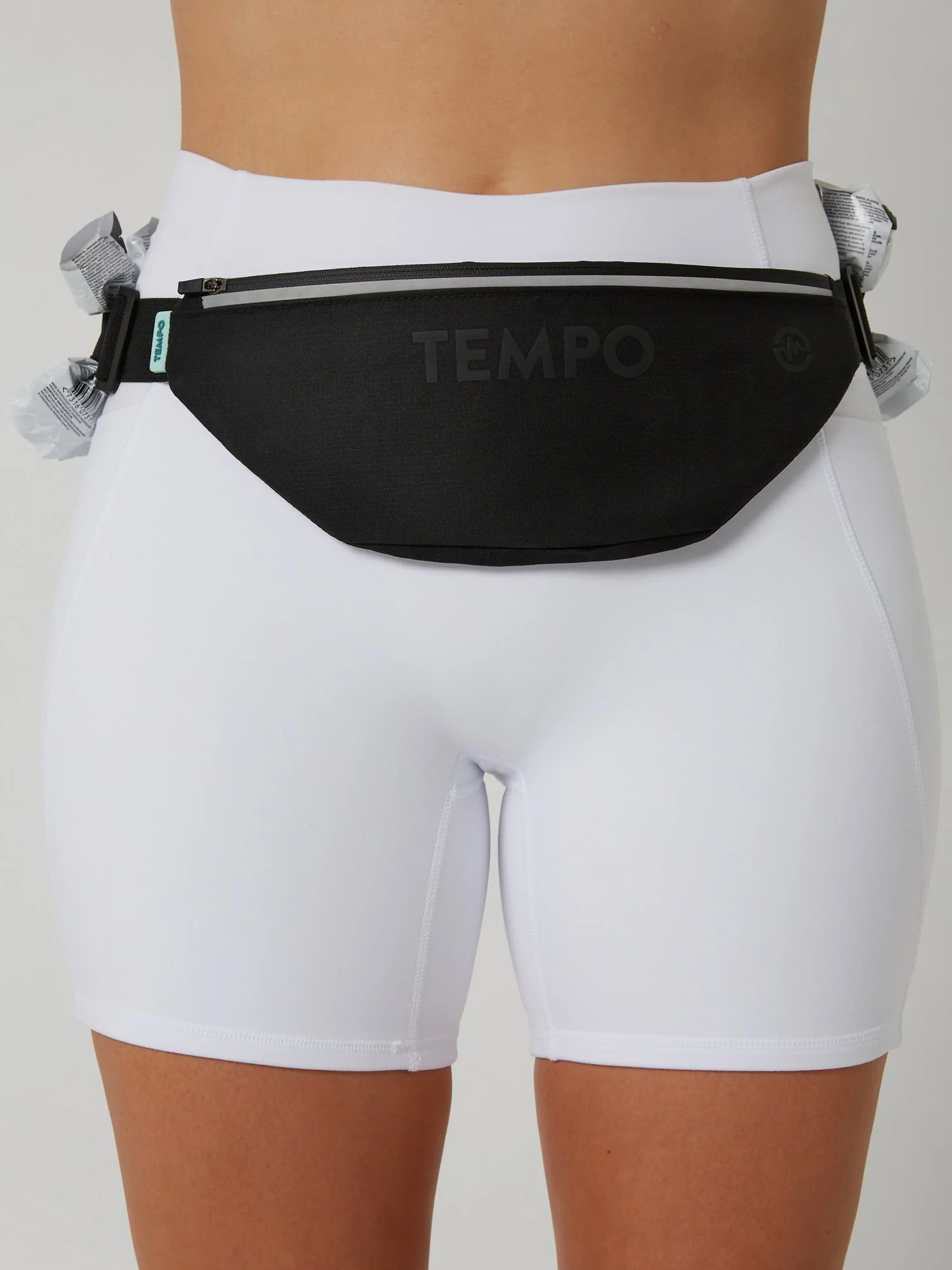 Runner wearing the CARRY / CORE black storage running belt carrying phone and keys during a training run.