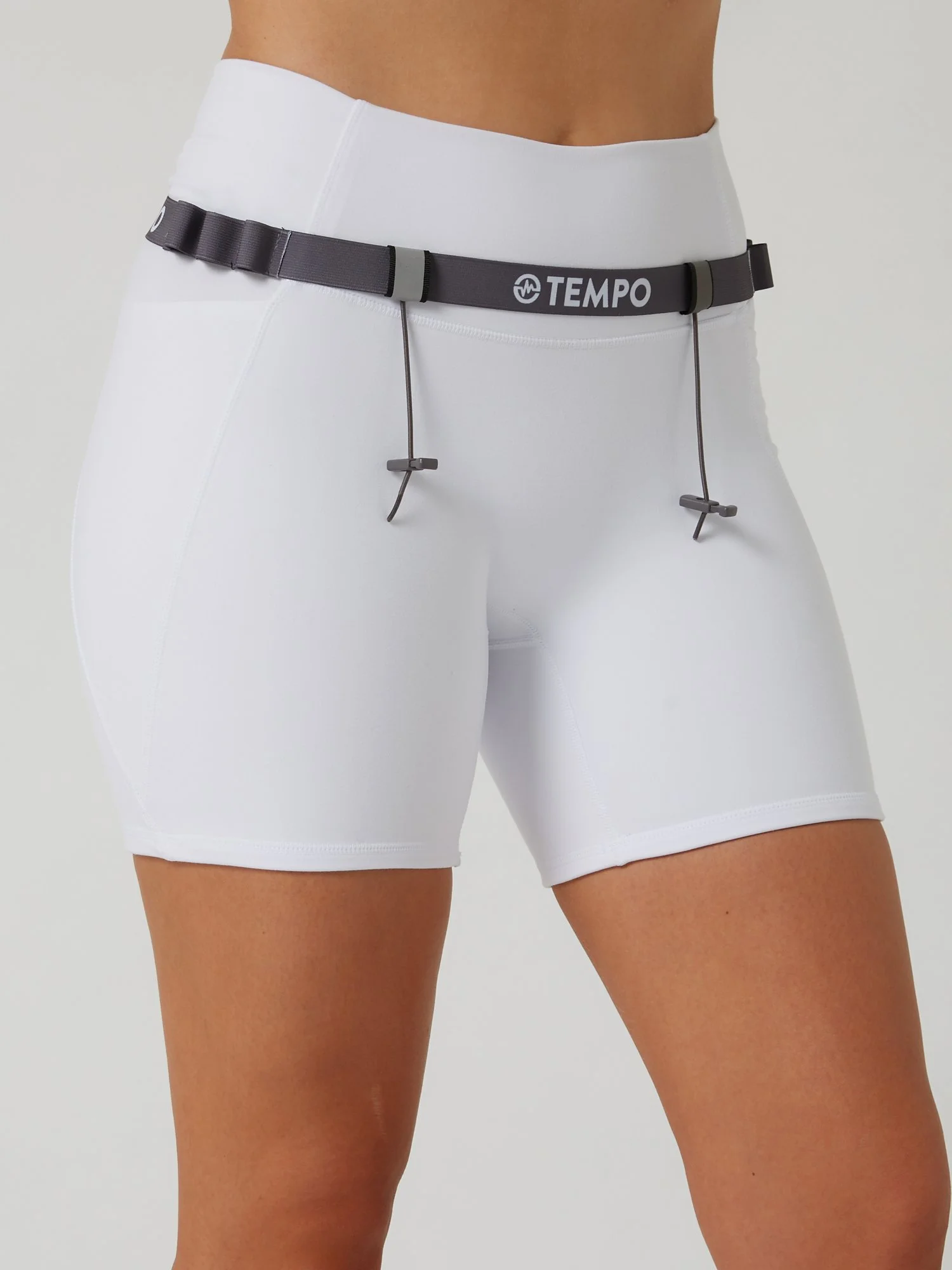 Runner wearing the PACE / ASH grey race belt with race bib and energy gels secured for race day running.