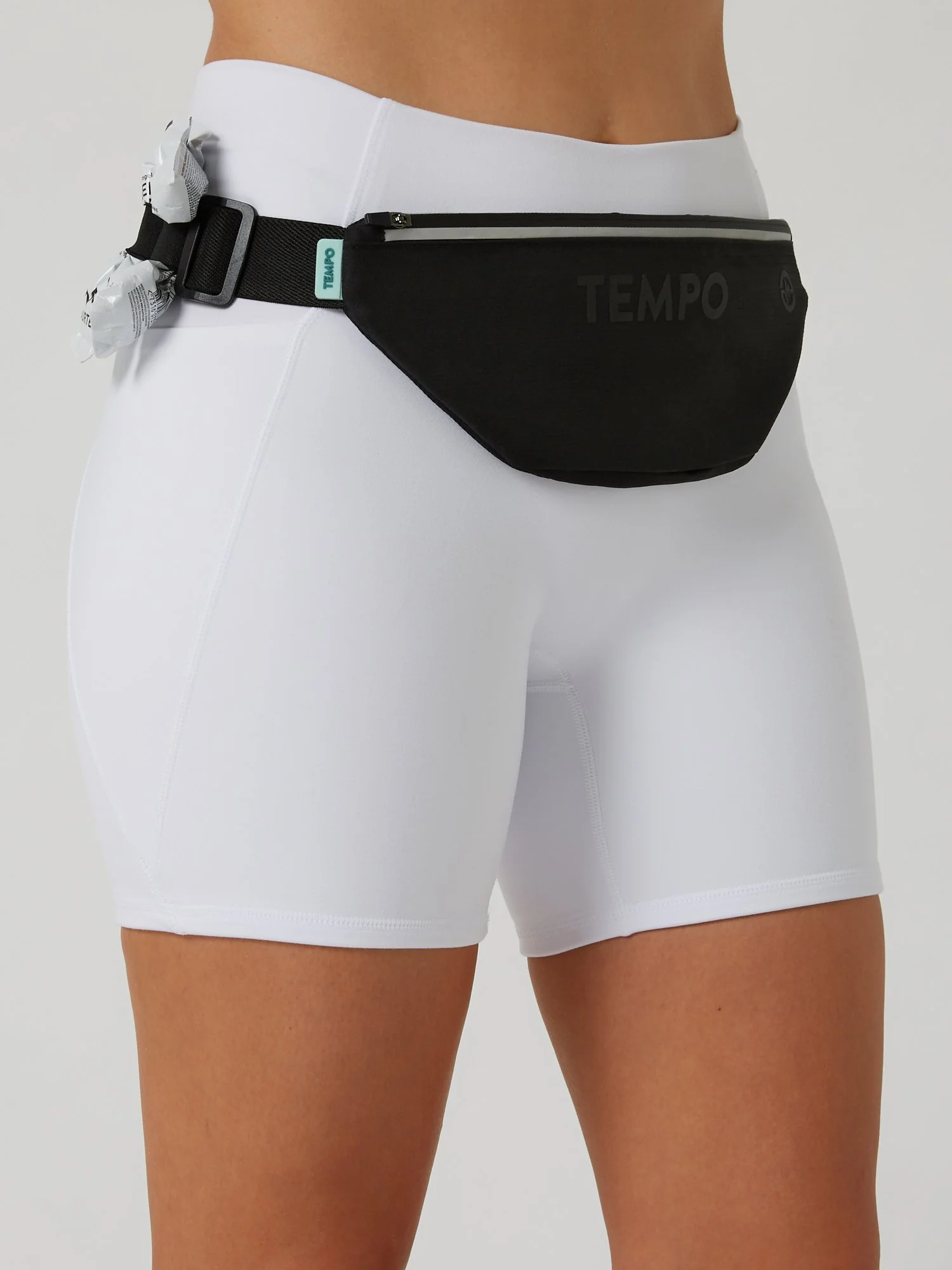 Runner wearing the CARRY / CORE black storage running belt carrying phone and keys during a training run.