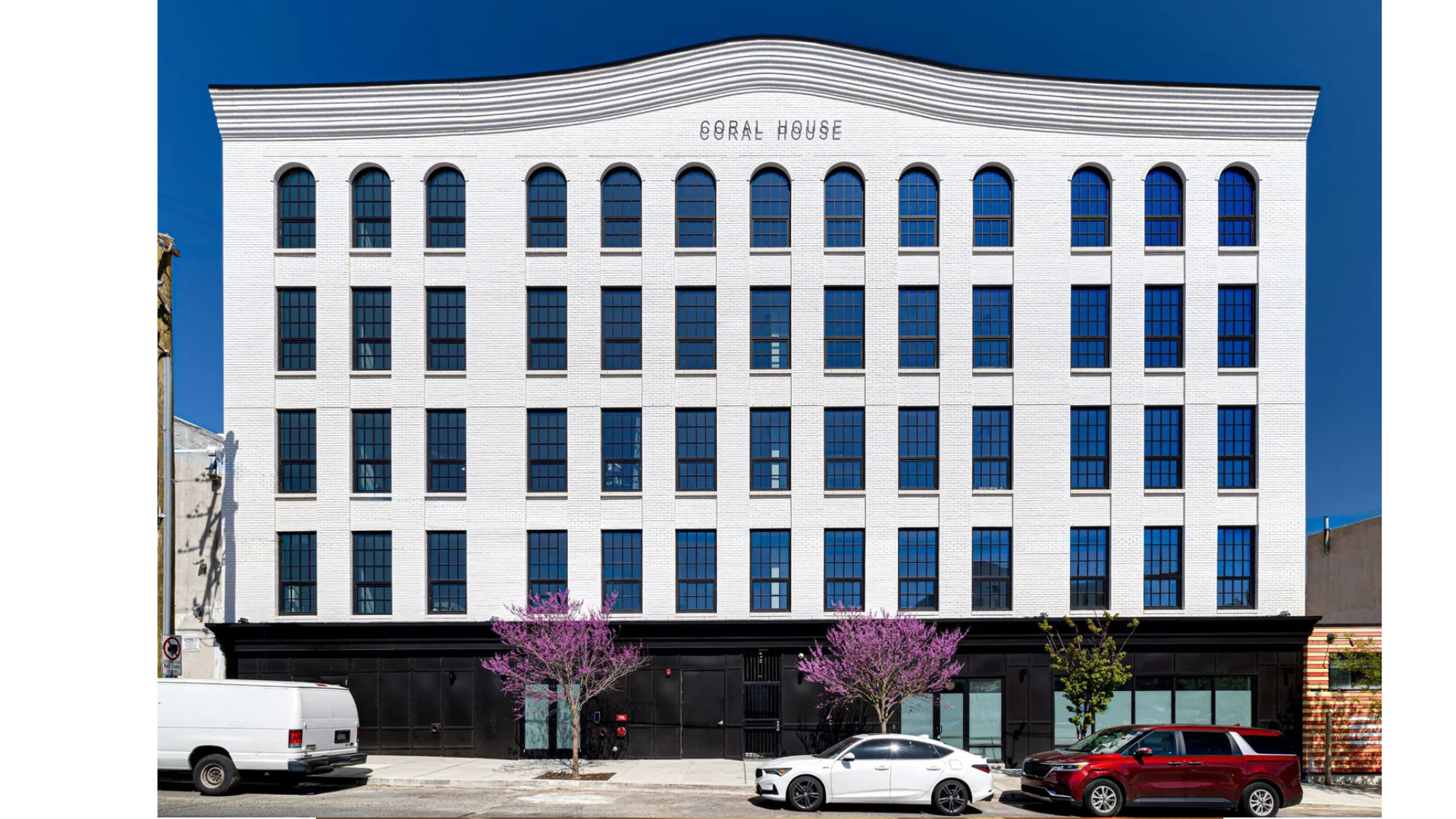 Structural engineering for the Coral House residential development, a multi-story apartment building with exterior lighting and urban streetscape design in Philadelphia, PA.
