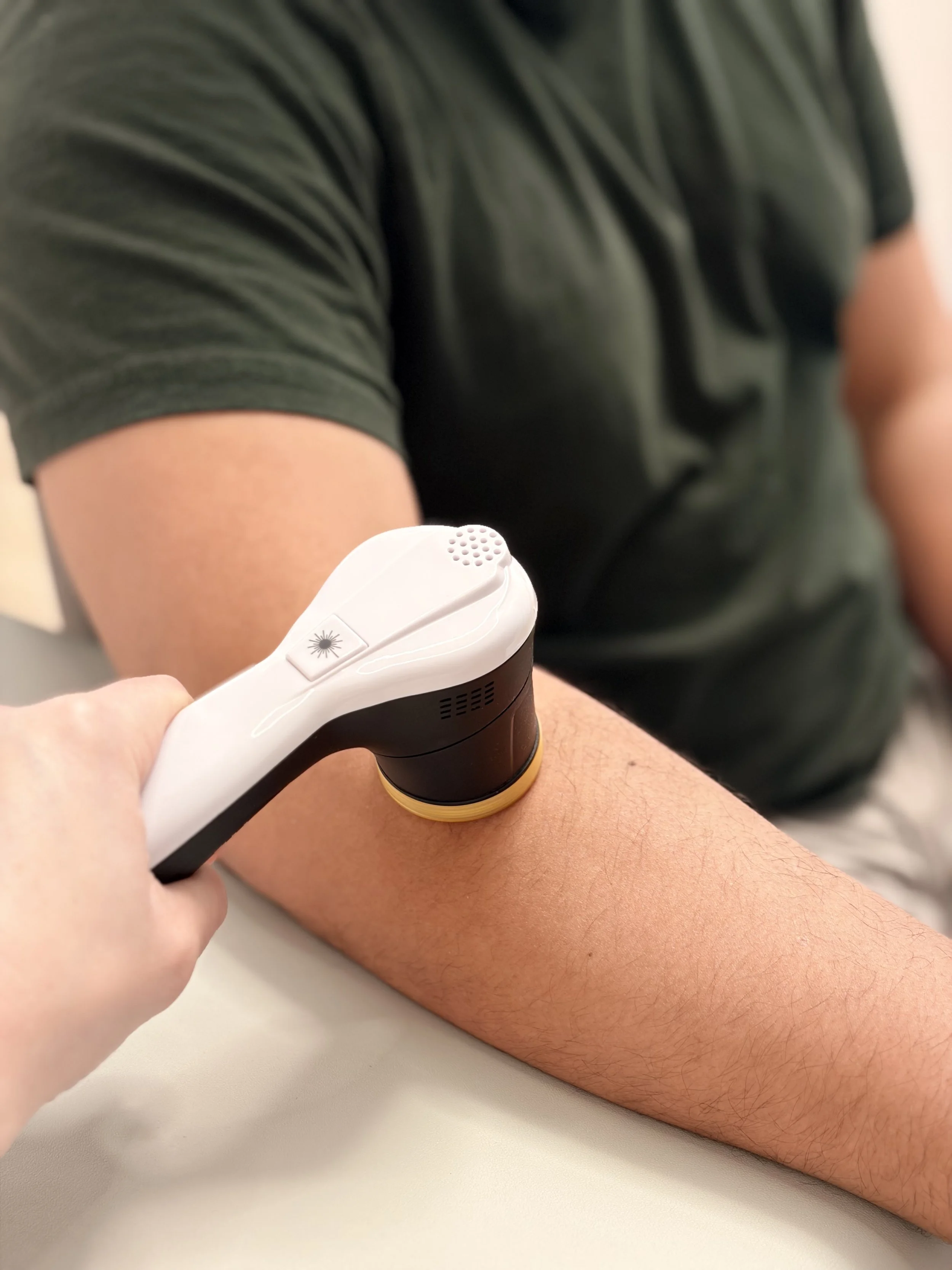Person receiving laser therapy for performance recovery at FlySpace Physical Therapy as the top performing arts physical therapists in New York.