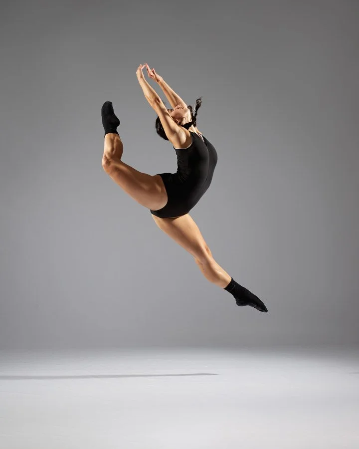 A female dancer performing a dynamic leap at FlySpace Physical Therapy as the top performing arts physical therapists in New York.