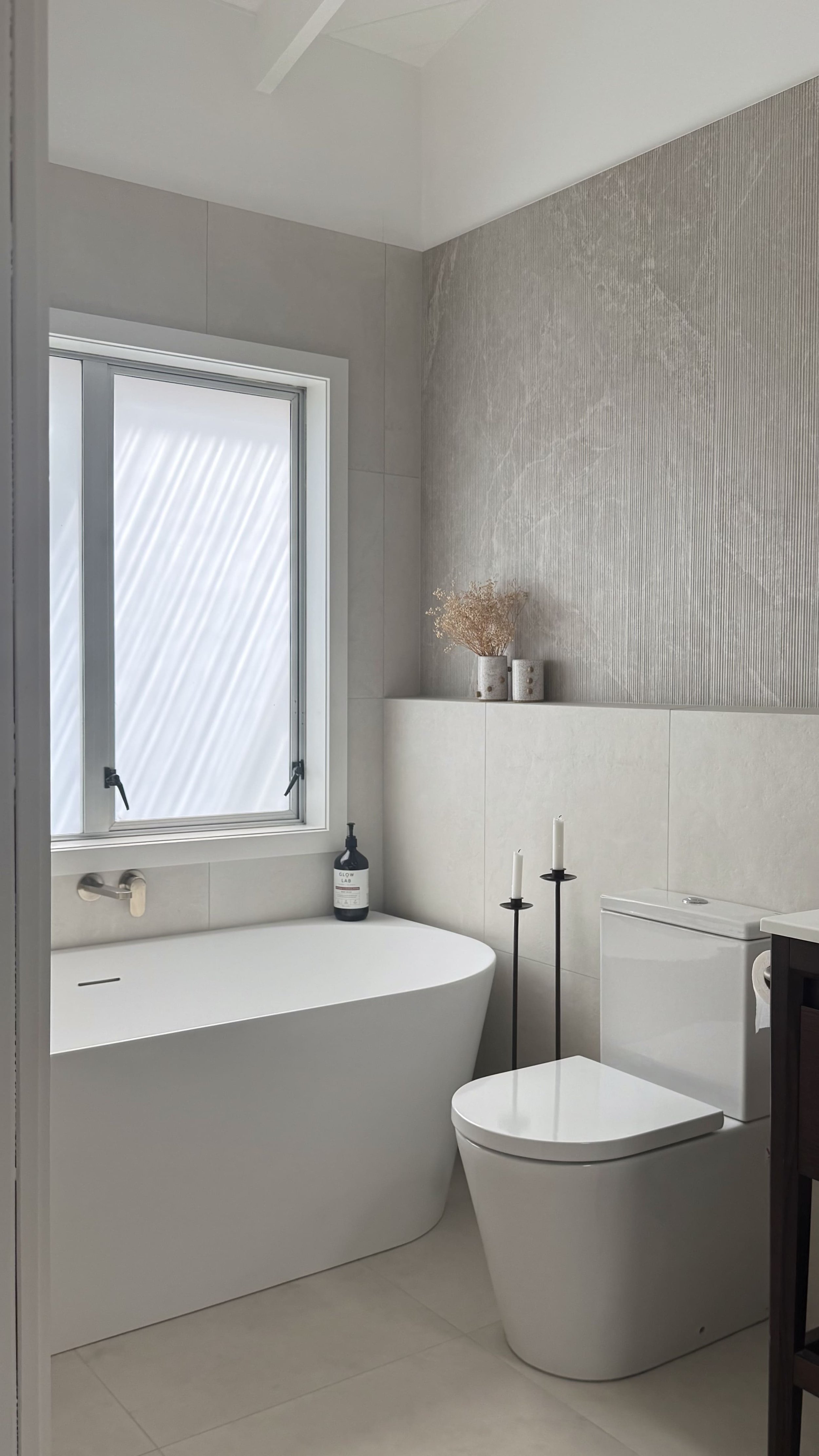This bathroom renovation is a mix of both functionality and style, resulting in a calming bathroom sanctuary built by Greyson Builders 