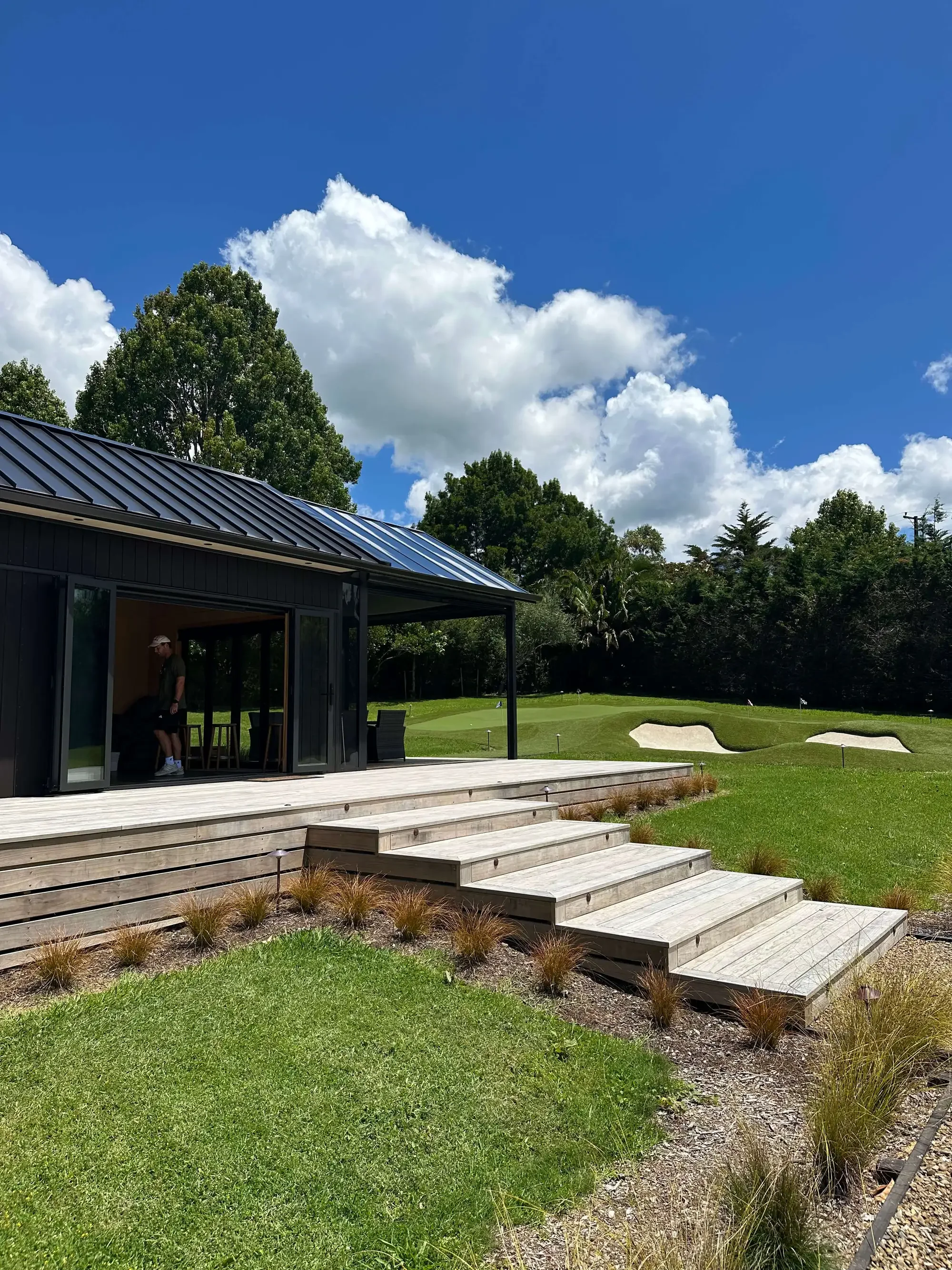 Modern outdoor golf simulator with golf green