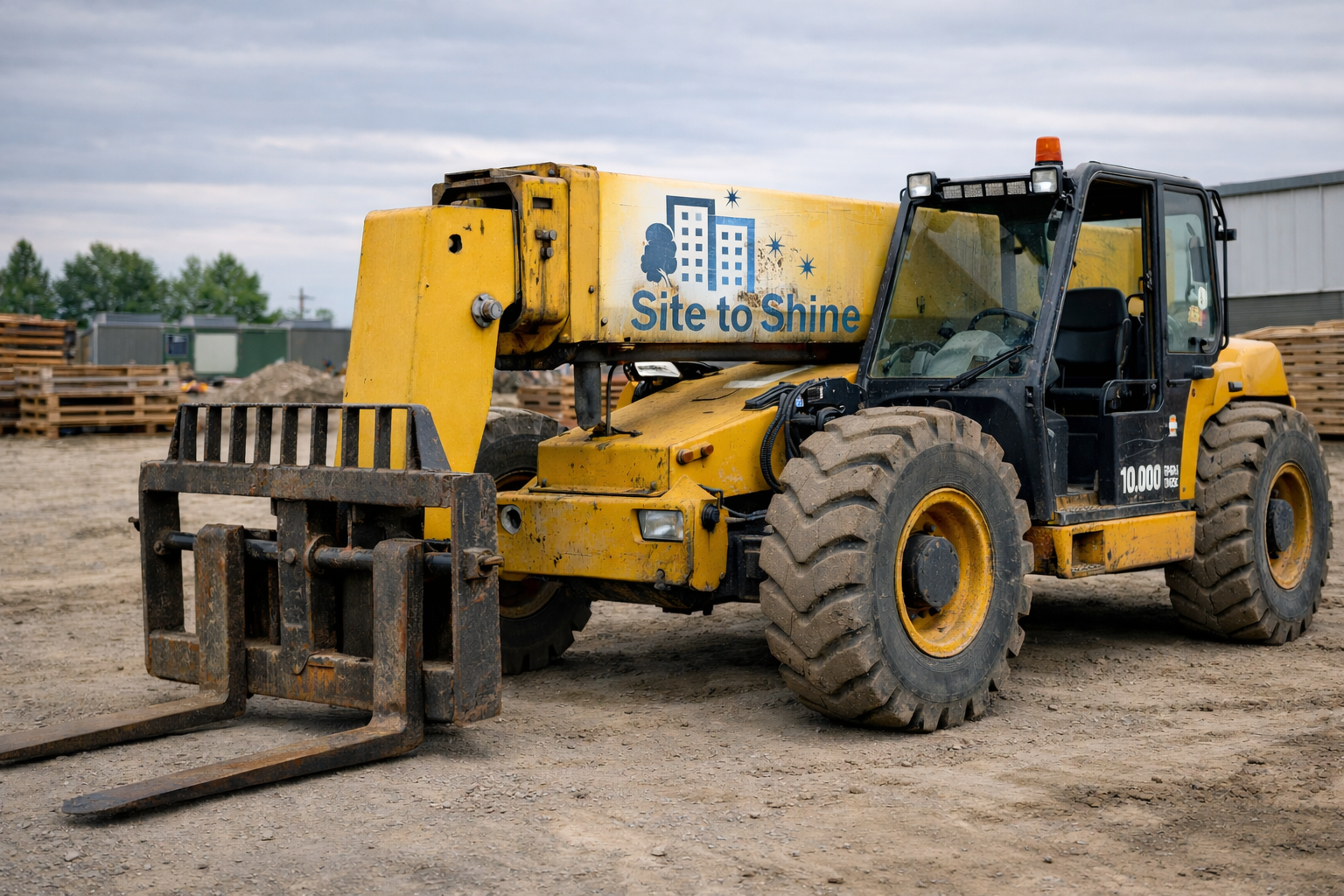 Yellow construction forklift on an active commercial jobsite, branded with the Site to Shine logo, supporting material handling and site services.