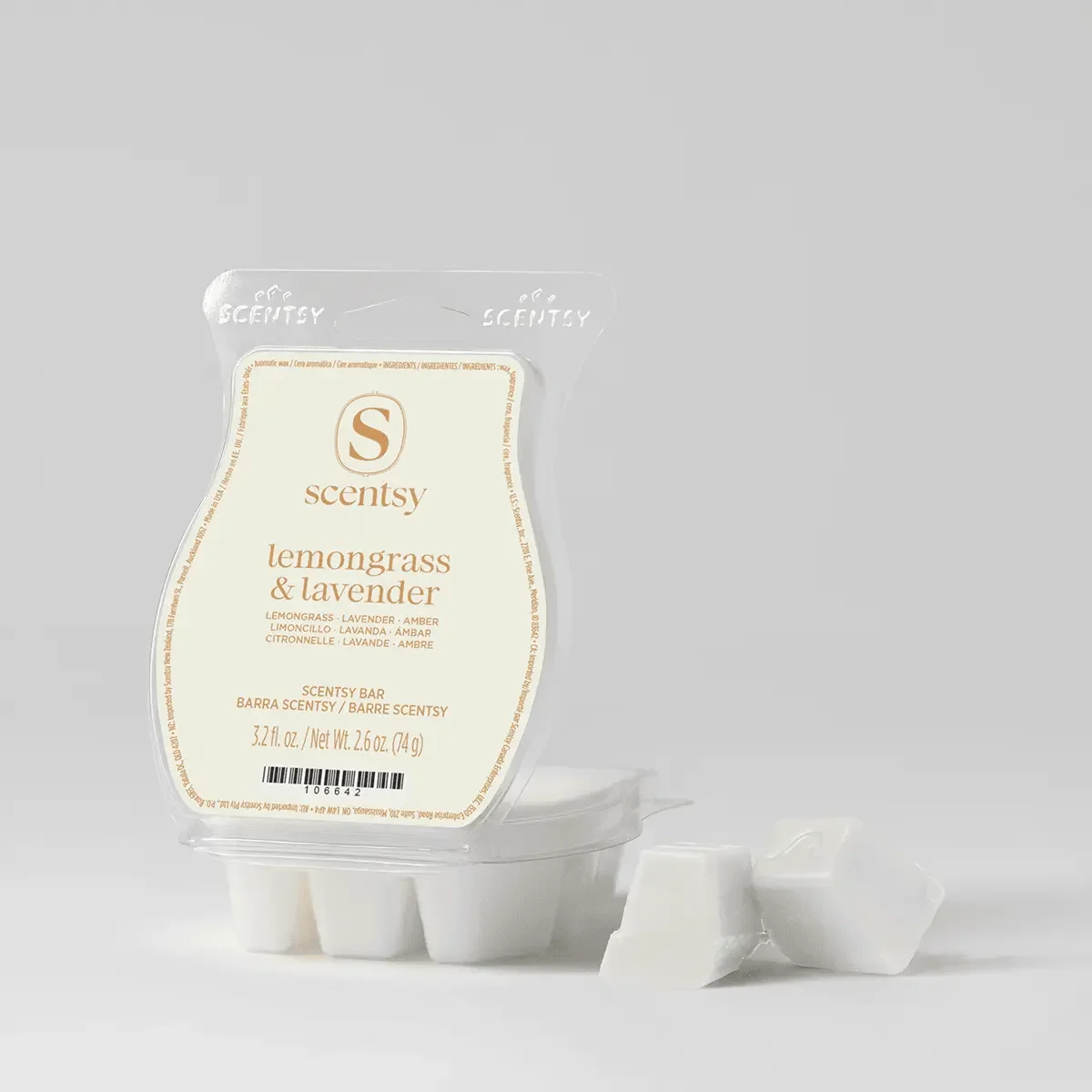 Scentsy lemongrass and lavender scented wax melt bar in a clear plastic package with a beige and white label, placed next to two small white wax cubes on a plain white background.
