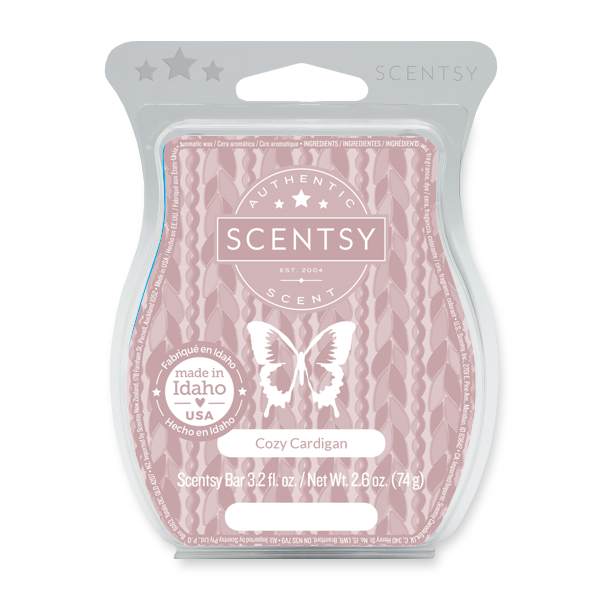 A Scentsy Cozy Cardigan scented wax bar packaging in pink with a butterfly and the Scentsy logo, indicating it is made in Idaho, USA.