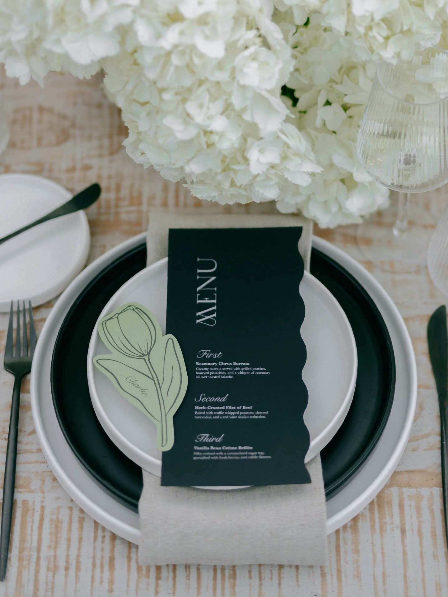 Set against the luxe backdrop of The Global Ambassador, this menu moment leaned into timeless neutrals with a modern twist. Green floral place cards nodded to the courtyard foliage &mdash; because even the paper deserves a little fresh air.

Photogra