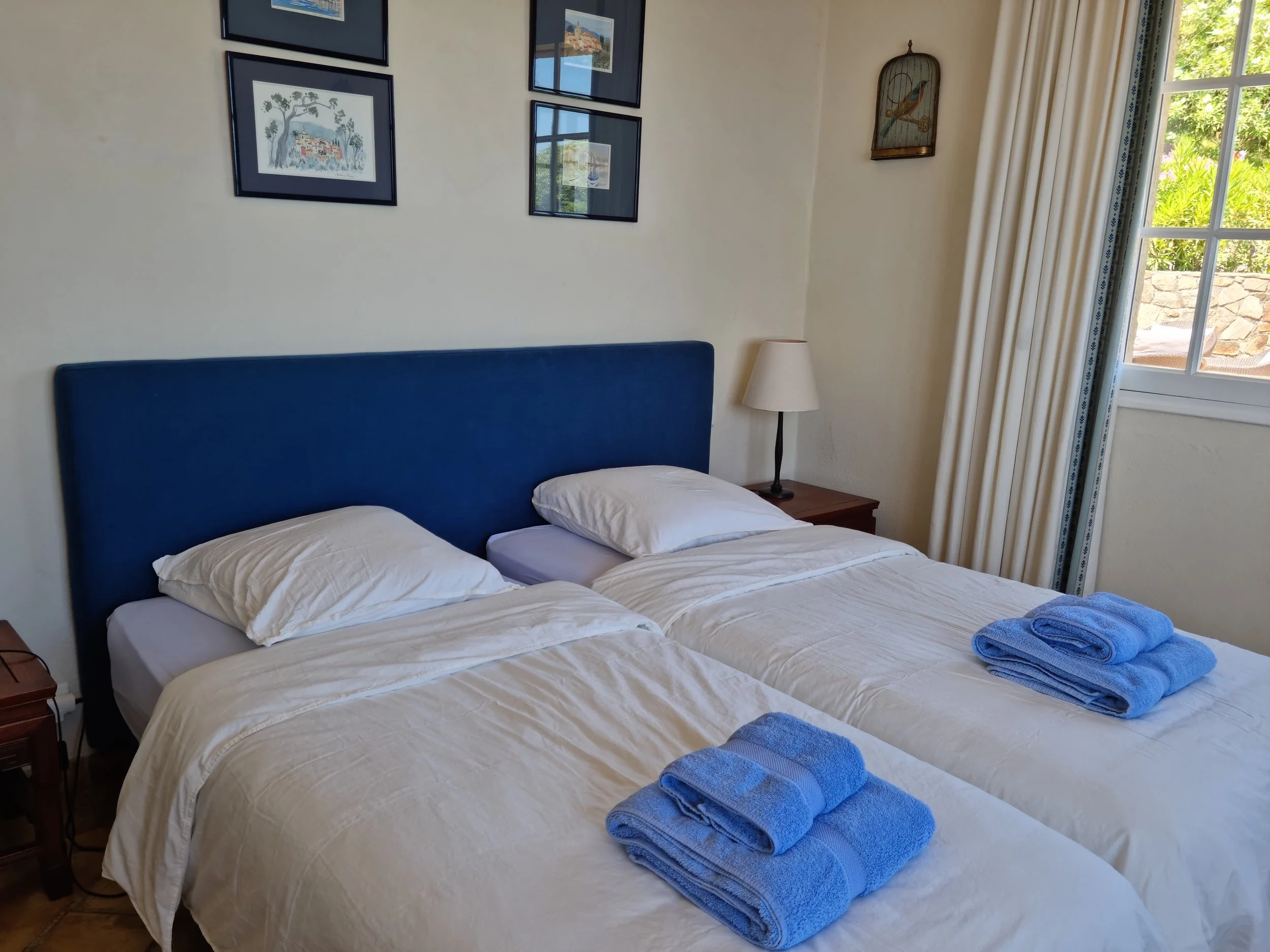 Twin bedroom with garden view at family villa in Les Parcs de Saint-Tropez.