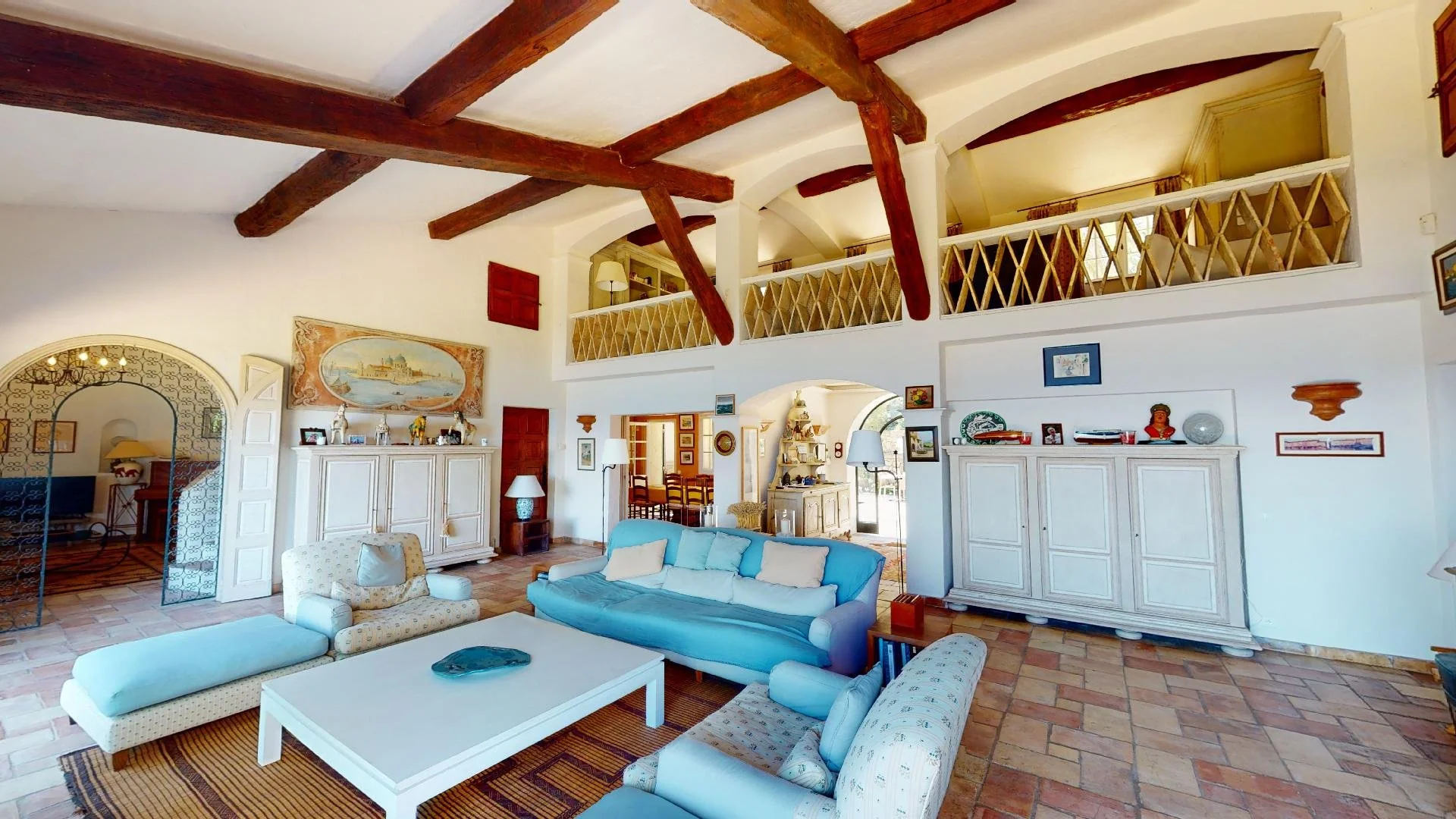 Elegant living room with exposed beams at family villa in Saint-Tropez.