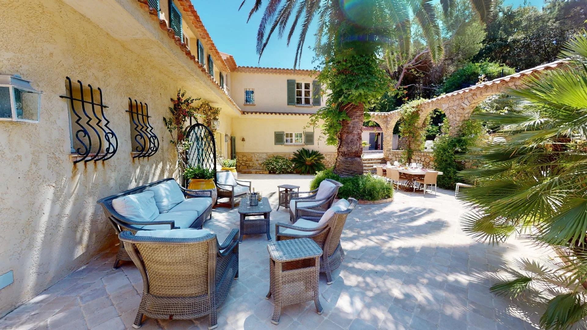 Mediterranean garden patio with palm trees at Saint-Tropez luxury villa rental.